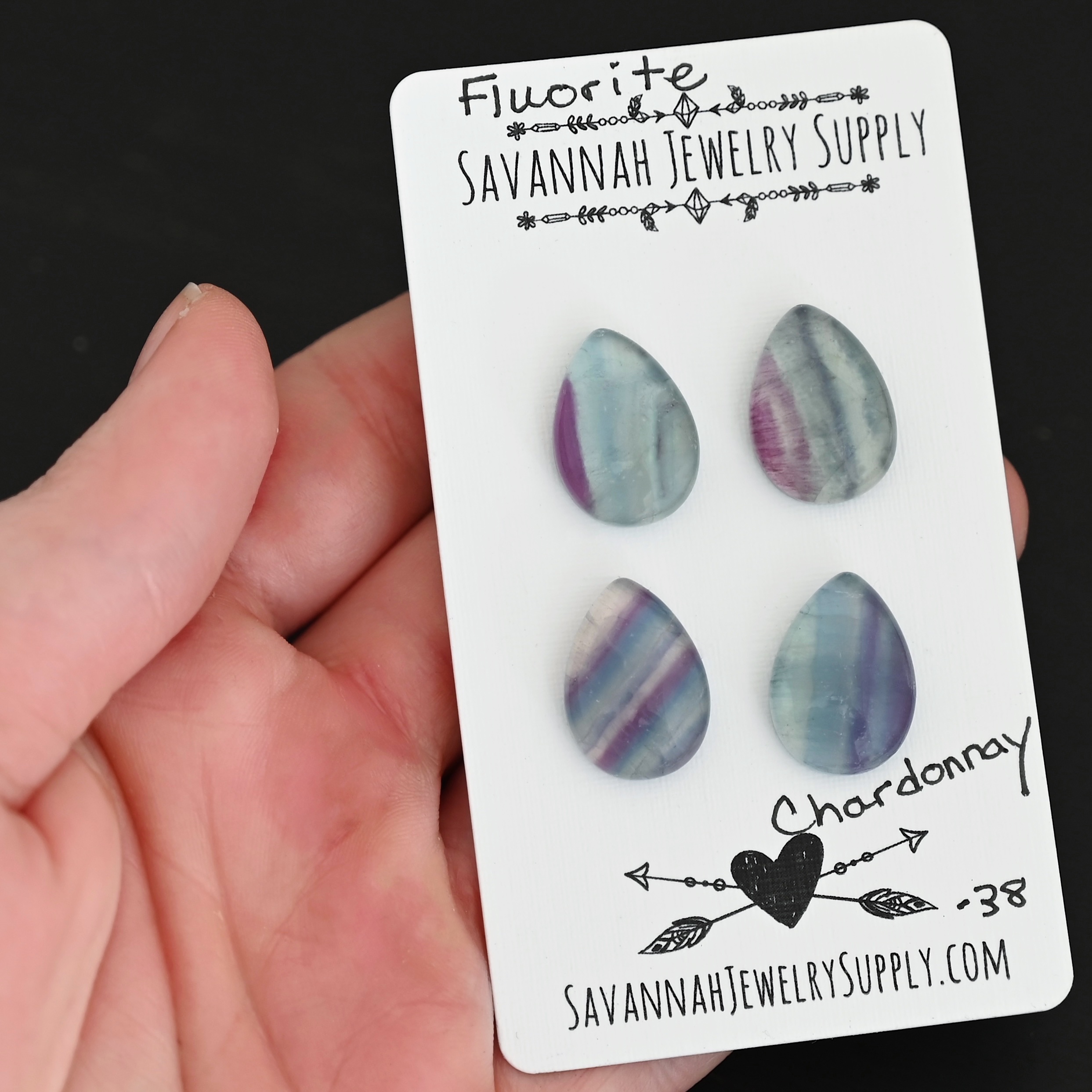 Chardonnay Fluorite Cabochon Parcel shown in hand
