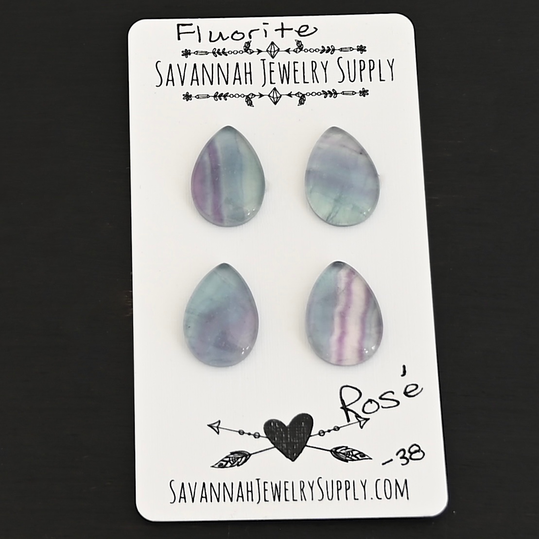 Rose Fluorite Cabochon Parcel shown on business card