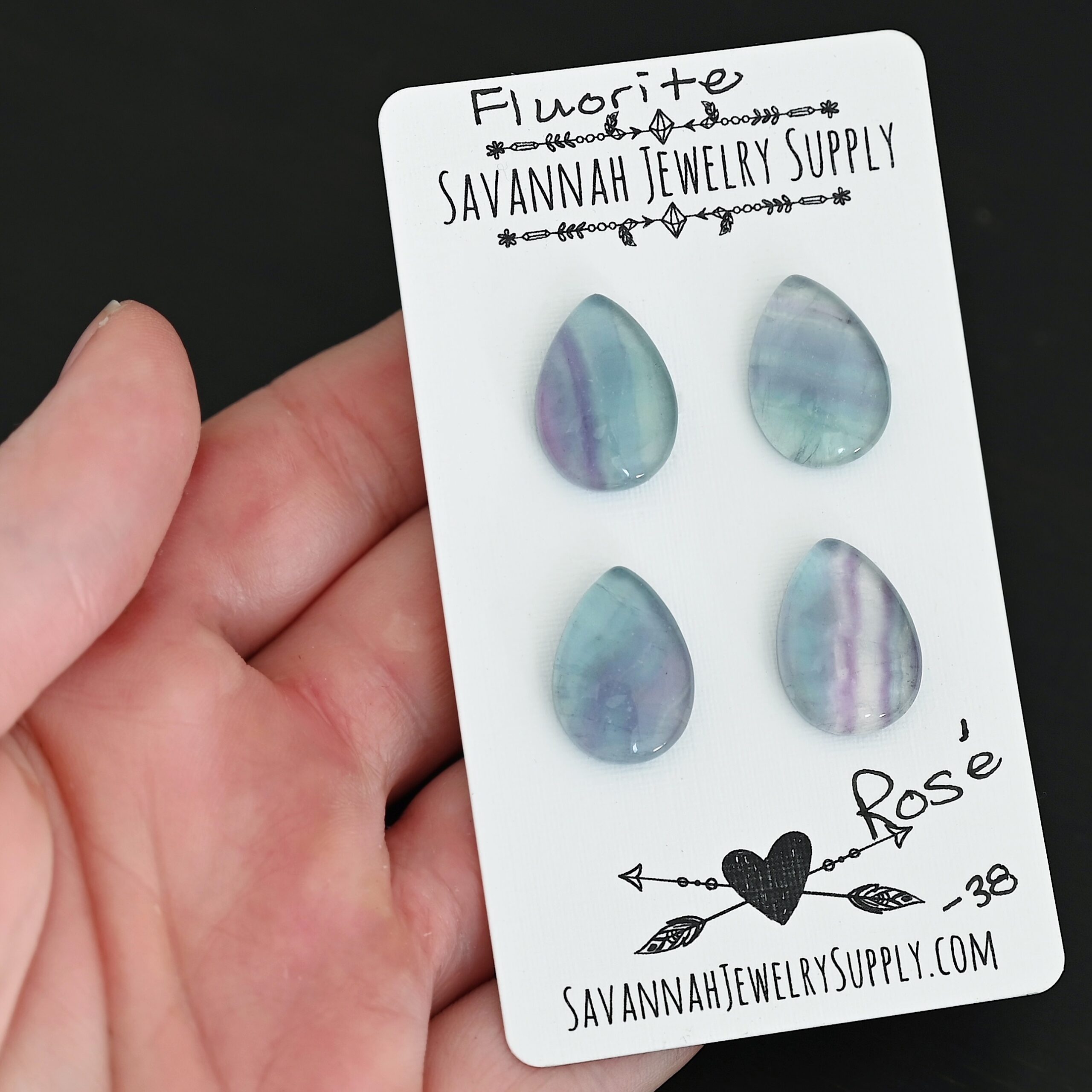 Rose Fluorite Cabochon Parcel shown in hand