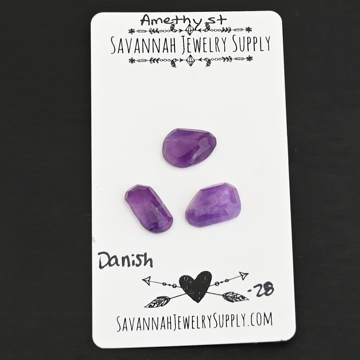 Danish Rose Cut Amethyst Cabochon Parcel shown on business card