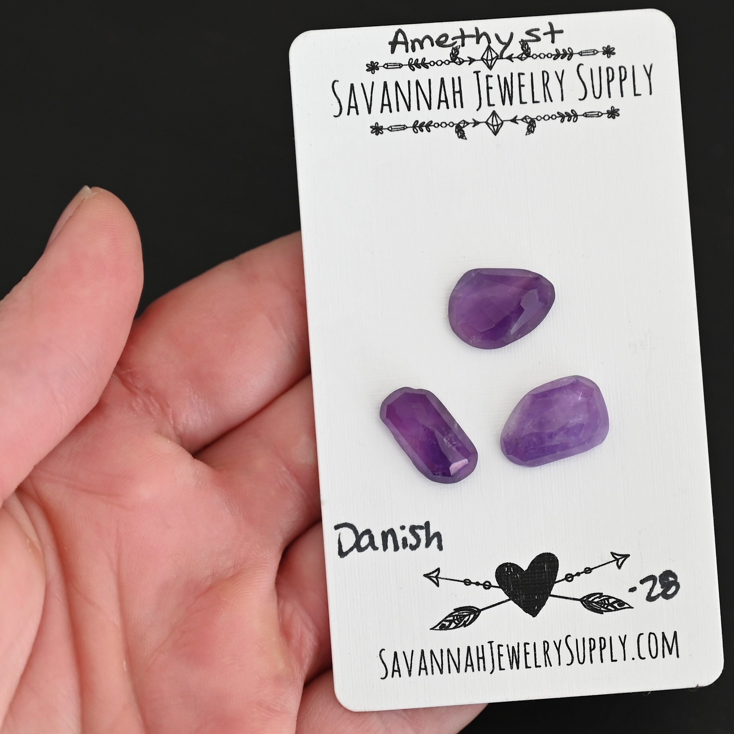 Danish Rose Cut Amethyst Cabochon Parcel shown in hand
