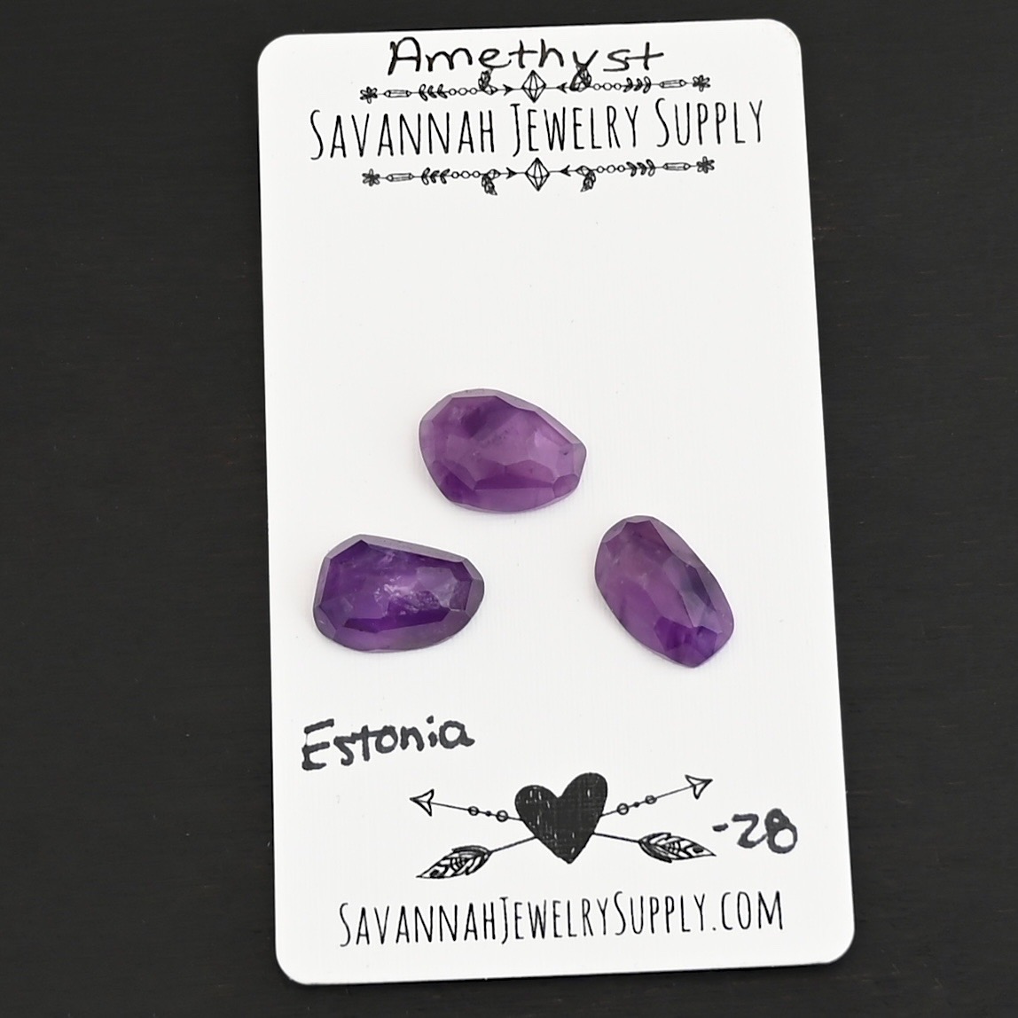 Estonia Rose Cut Amethyst Cabochon Parcel shown on business card