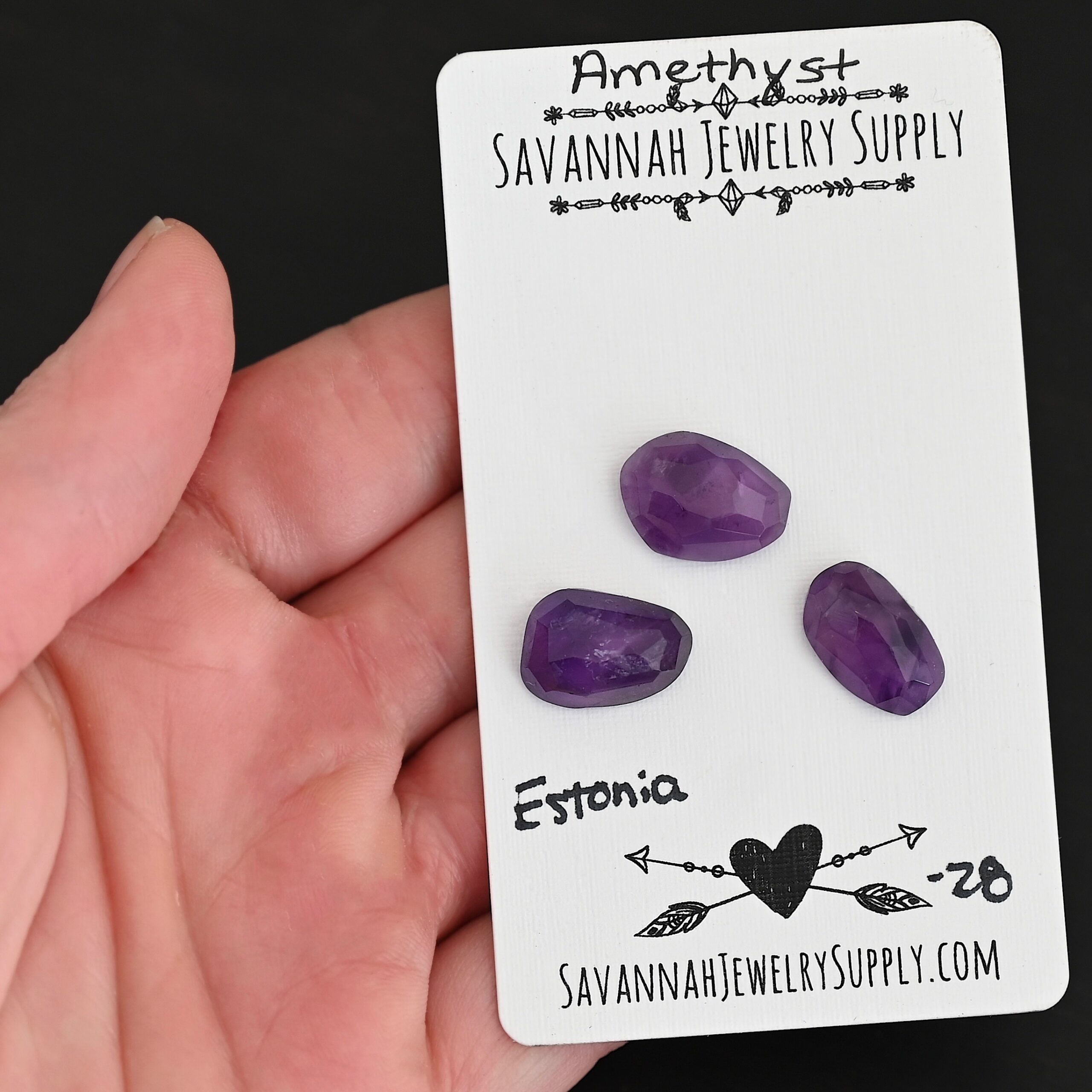 Estonia Rose Cut Amethyst Cabochon Parcel shown in hand
