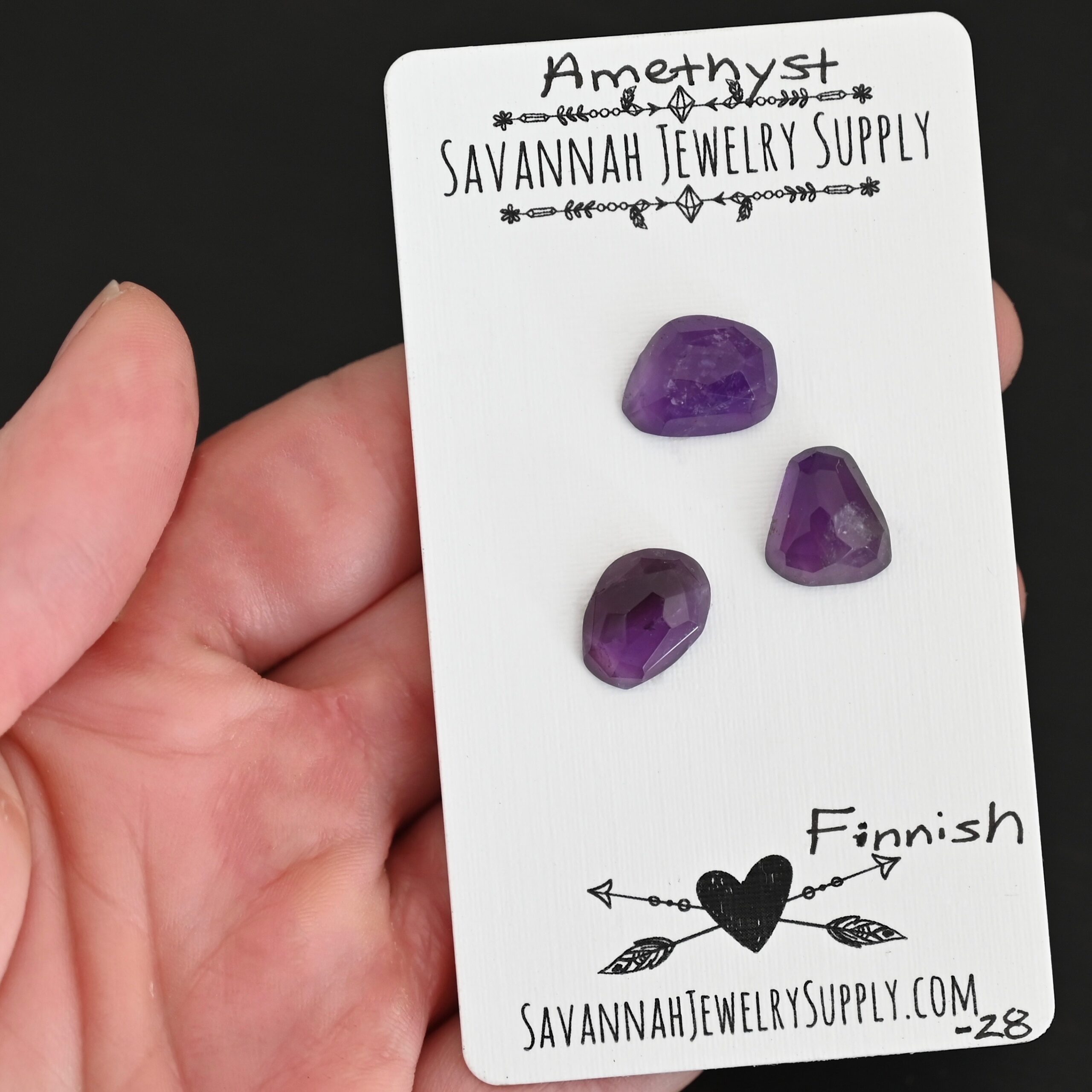 Finnish Rose Cut Amethyst Cabochon Parcel shown in hand