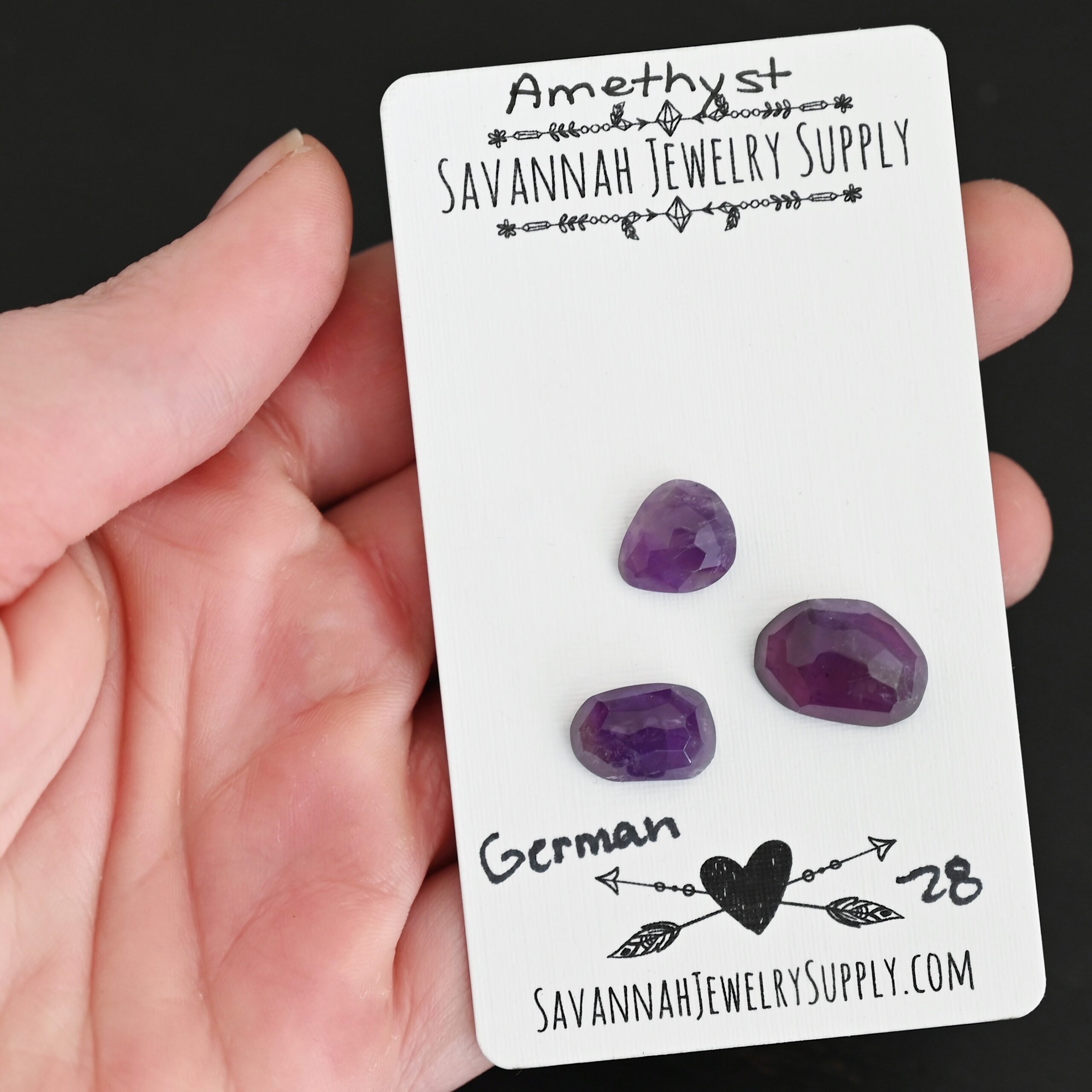 German Rose Cut Amethyst Cabochon Parcel shown in hand