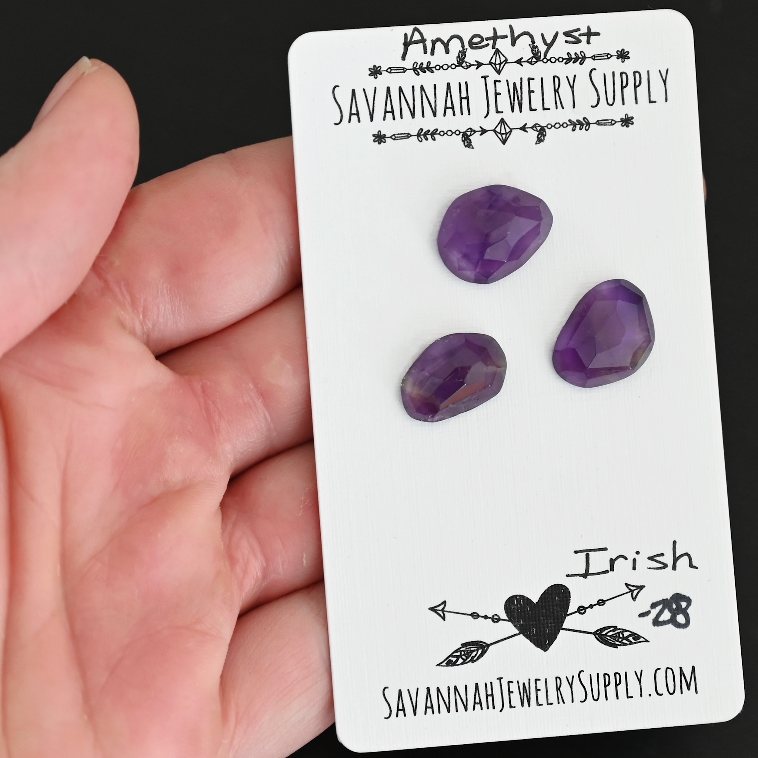 Icelandic Rose Cut Amethyst Cabochon Parcel shown in hand