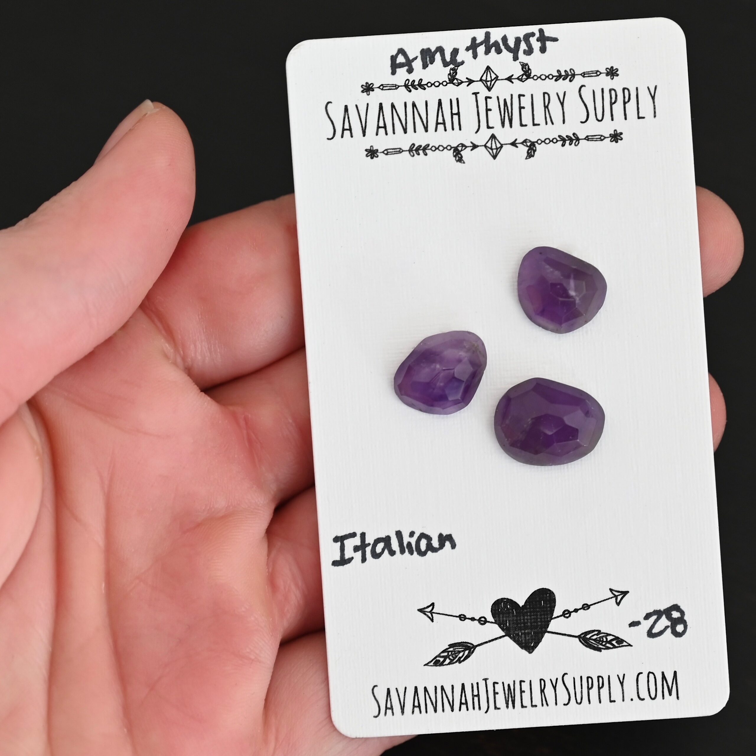 Italian Rose Cut Amethyst Cabochon Parcel shown in hand