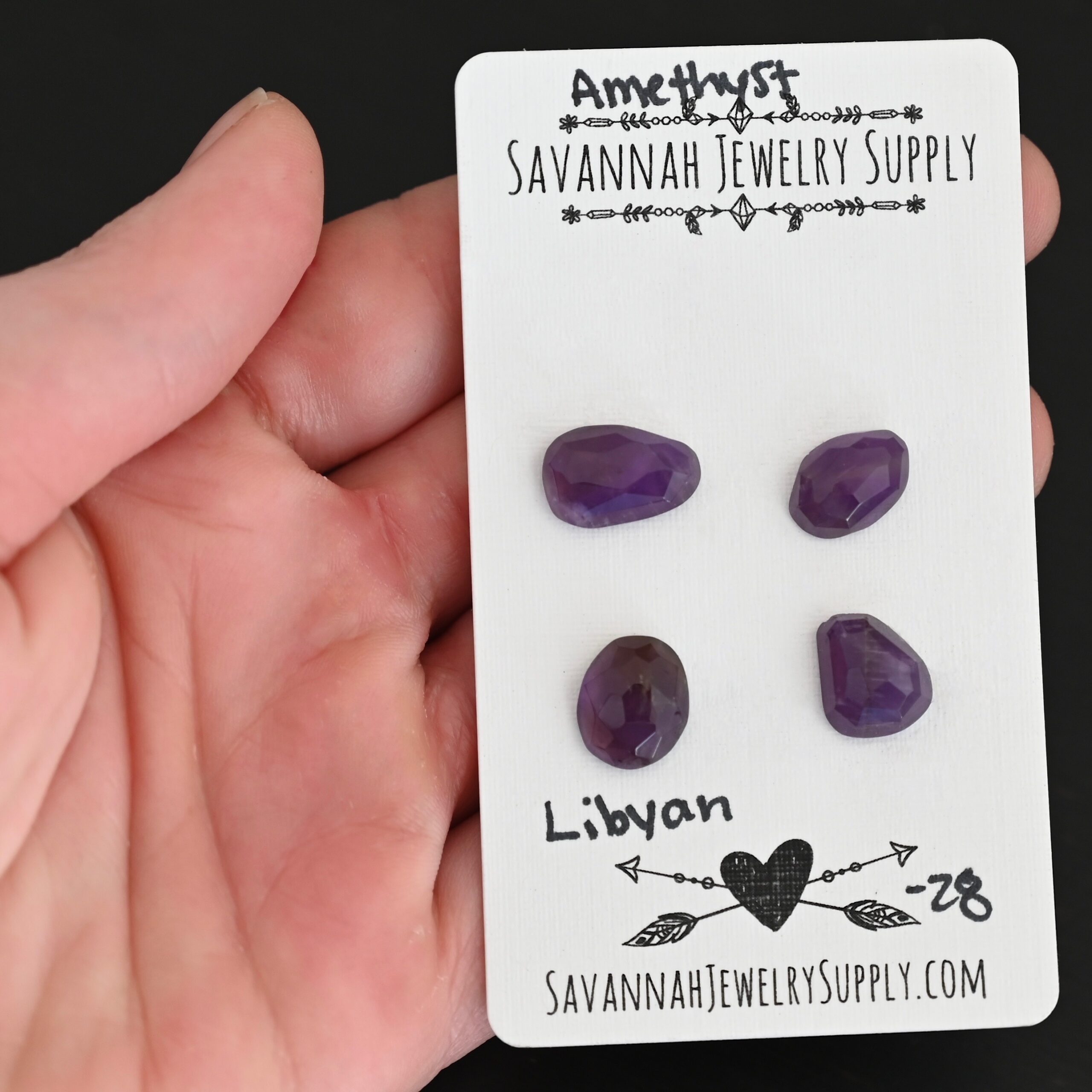 Libyan Rose Cut Amethyst Cabochon Parcel shown in hand