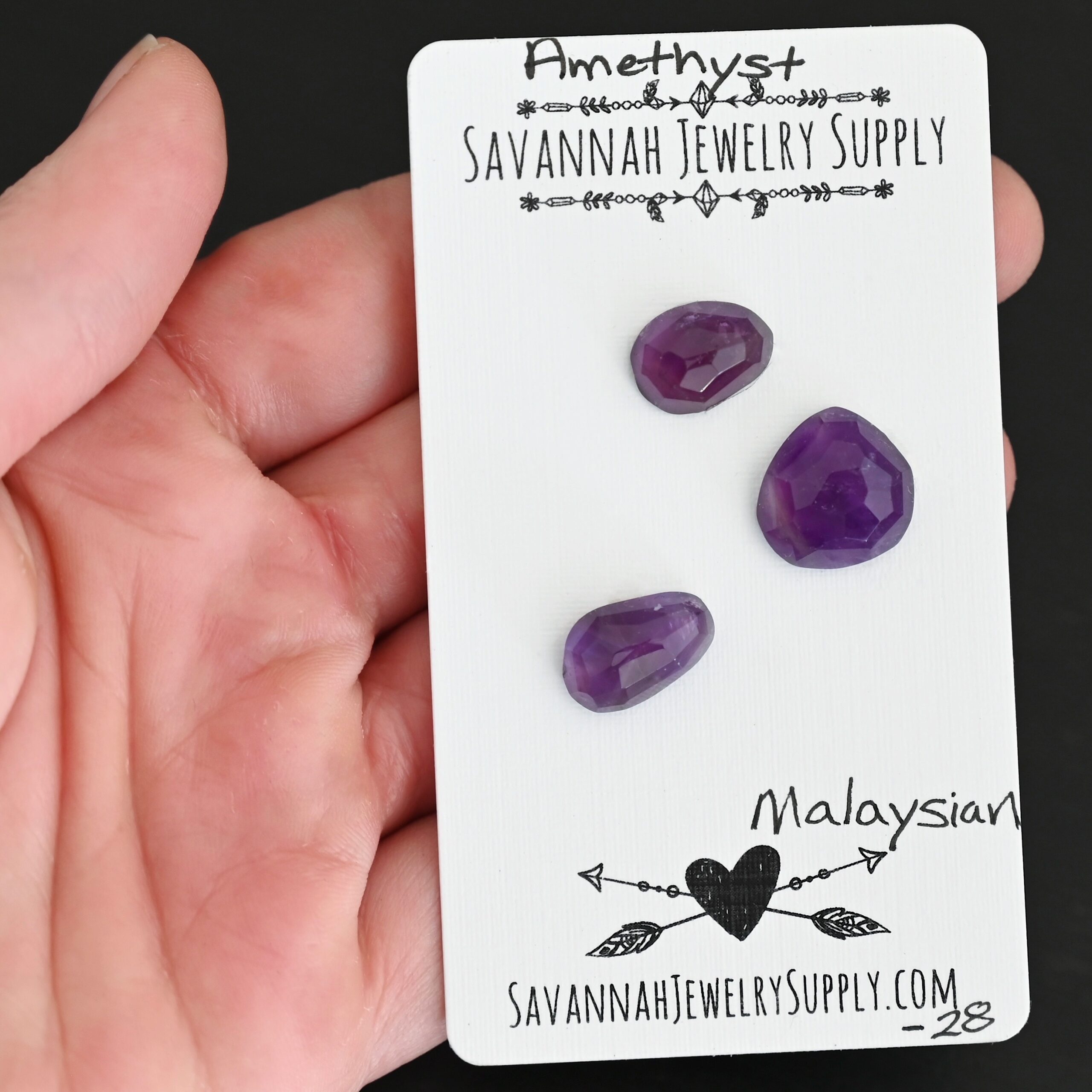 Malaysian Rose Cut Amethyst Cabochon Parcel shown in hand