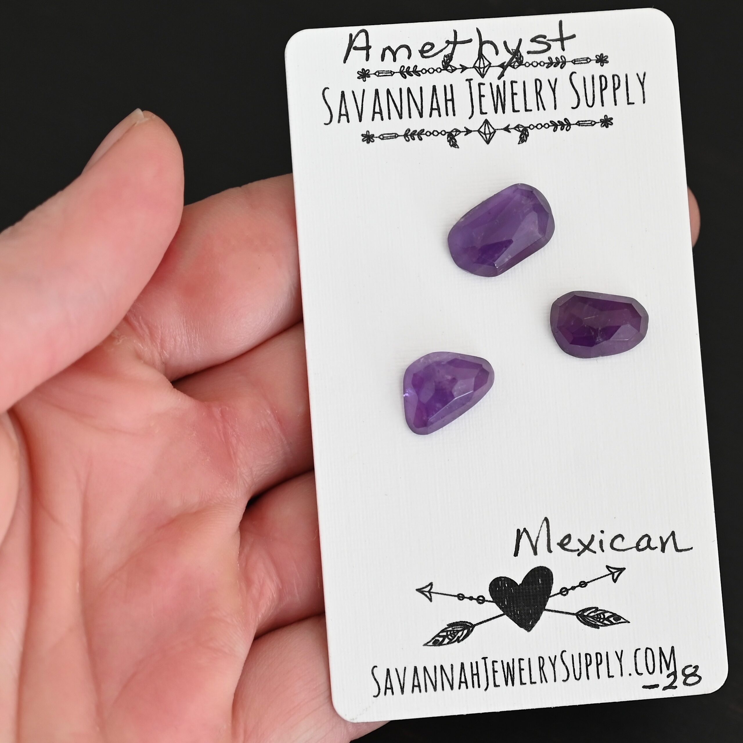 Mexican Rose Cut Amethyst Cabochon Parcel shown in hand