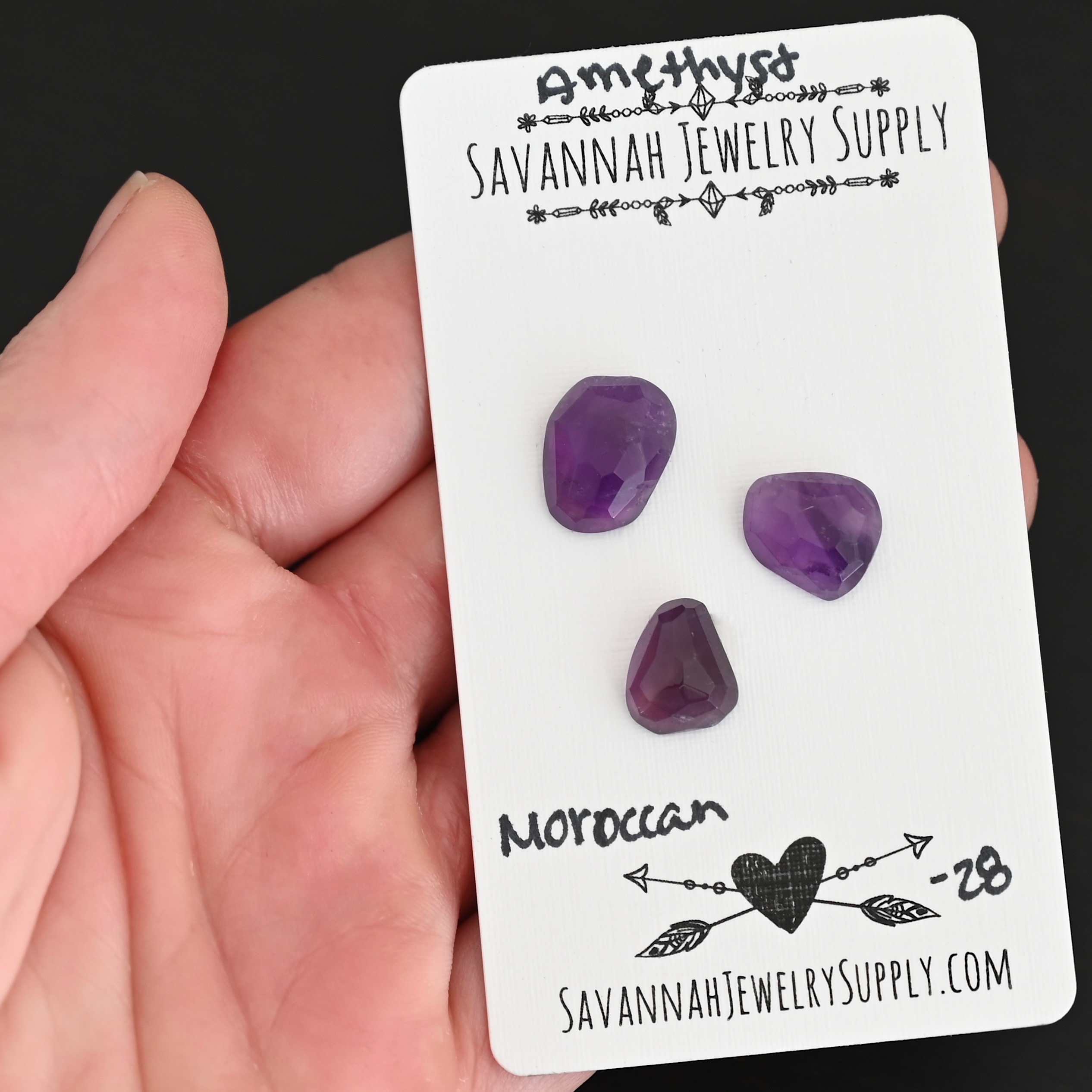 Moroccan Rose Cut Amethyst Cabochon Parcel shown in hand