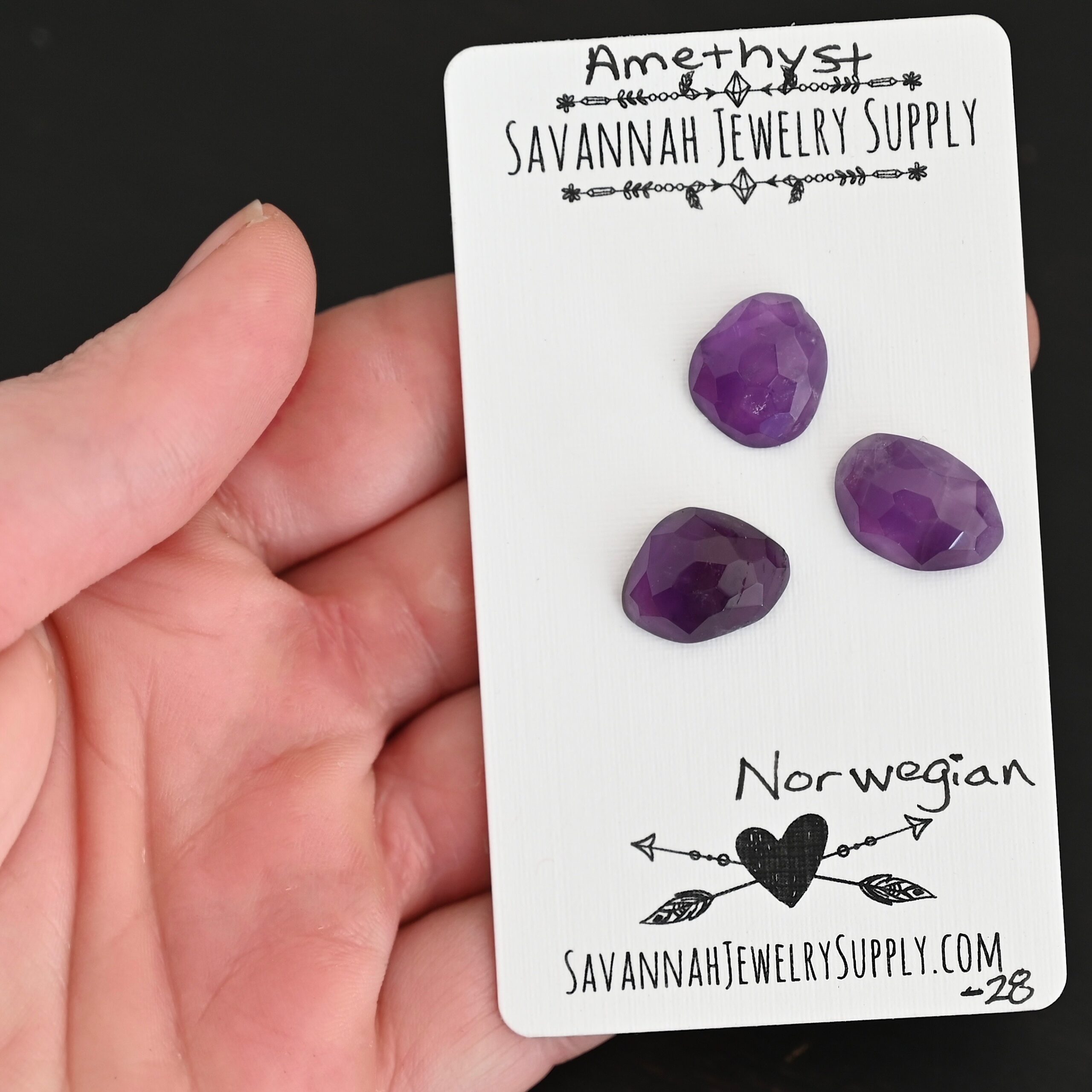 Norwegian Rose Cut Amethyst Cabochon Parcel shown in hand