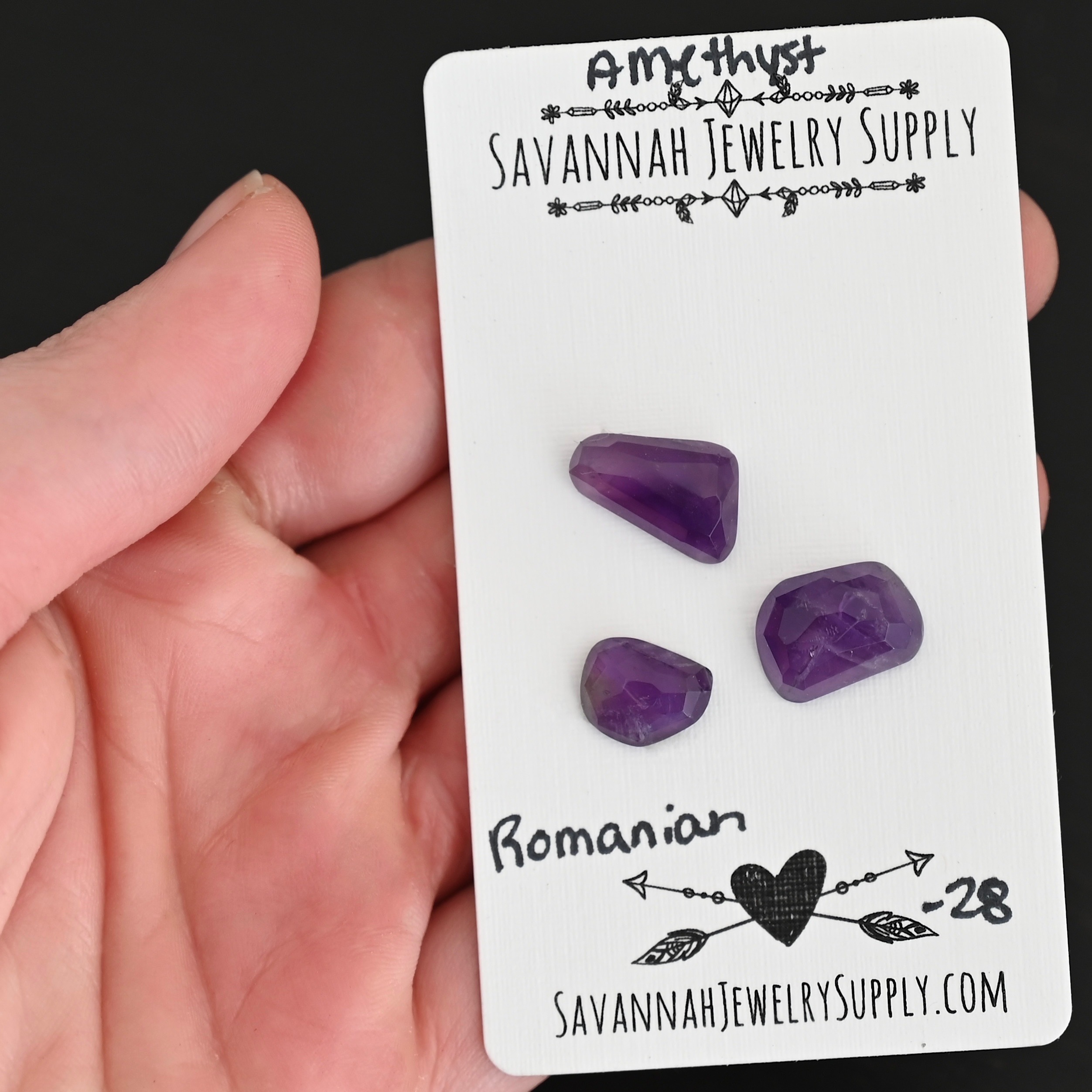Romanian Rose Cut Amethyst Cabochon Parcel shown in hand