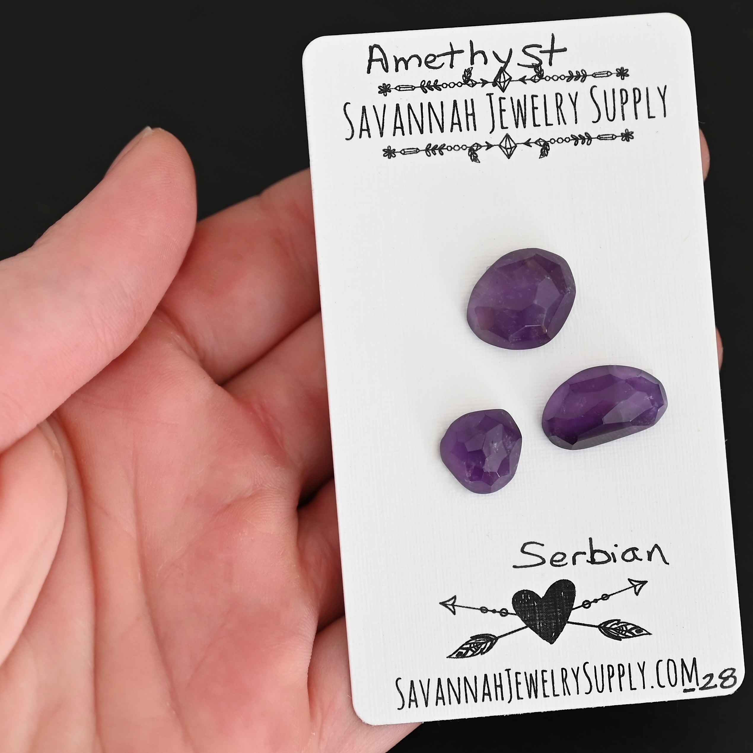 Serbian Rose Cut Amethyst Cabochon Parcel shown in hand