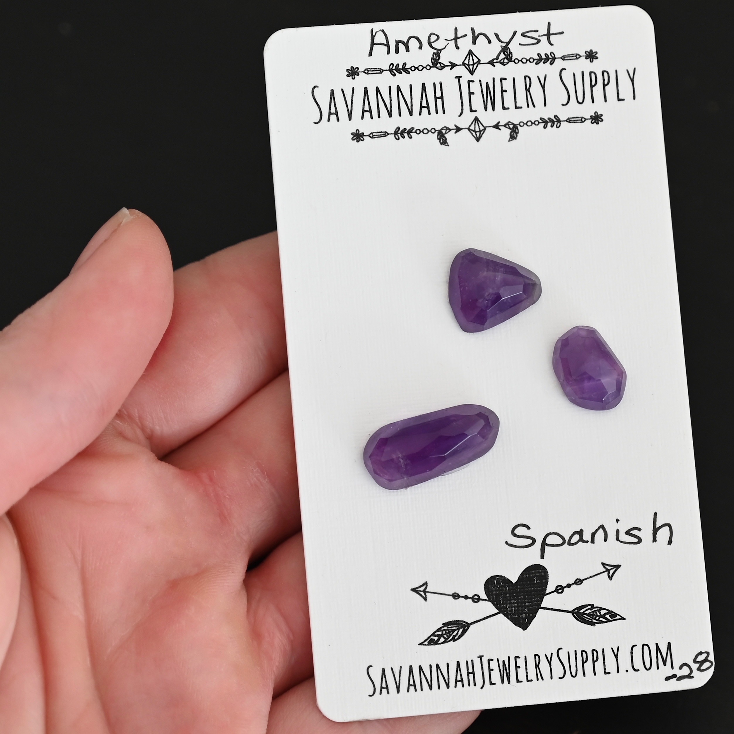 Spanish Rose Cut Amethyst Cabochon Parcel shown in hand
