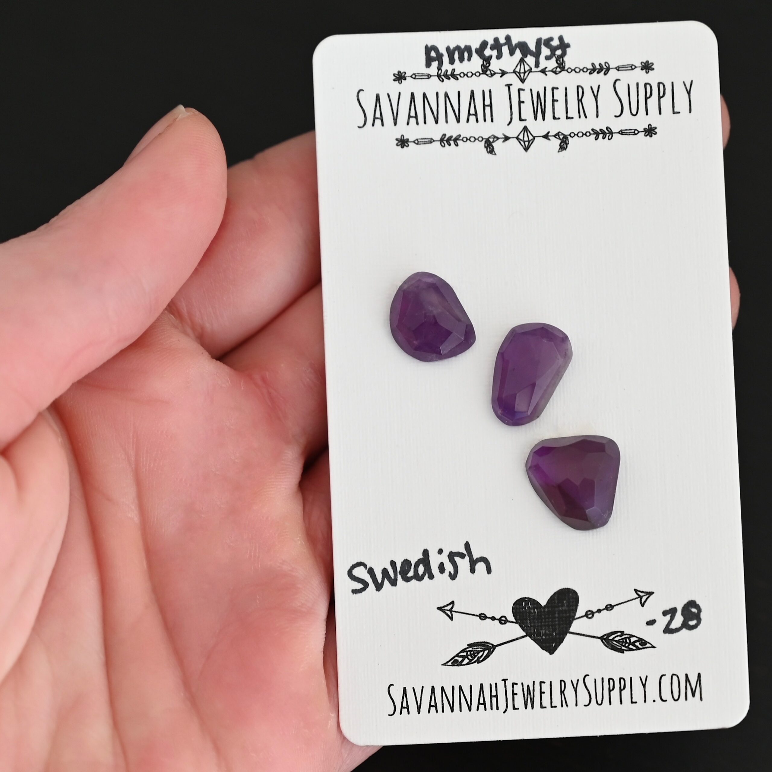 Swedish Rose Cut Amethyst Cabochon Parcel shown in hand