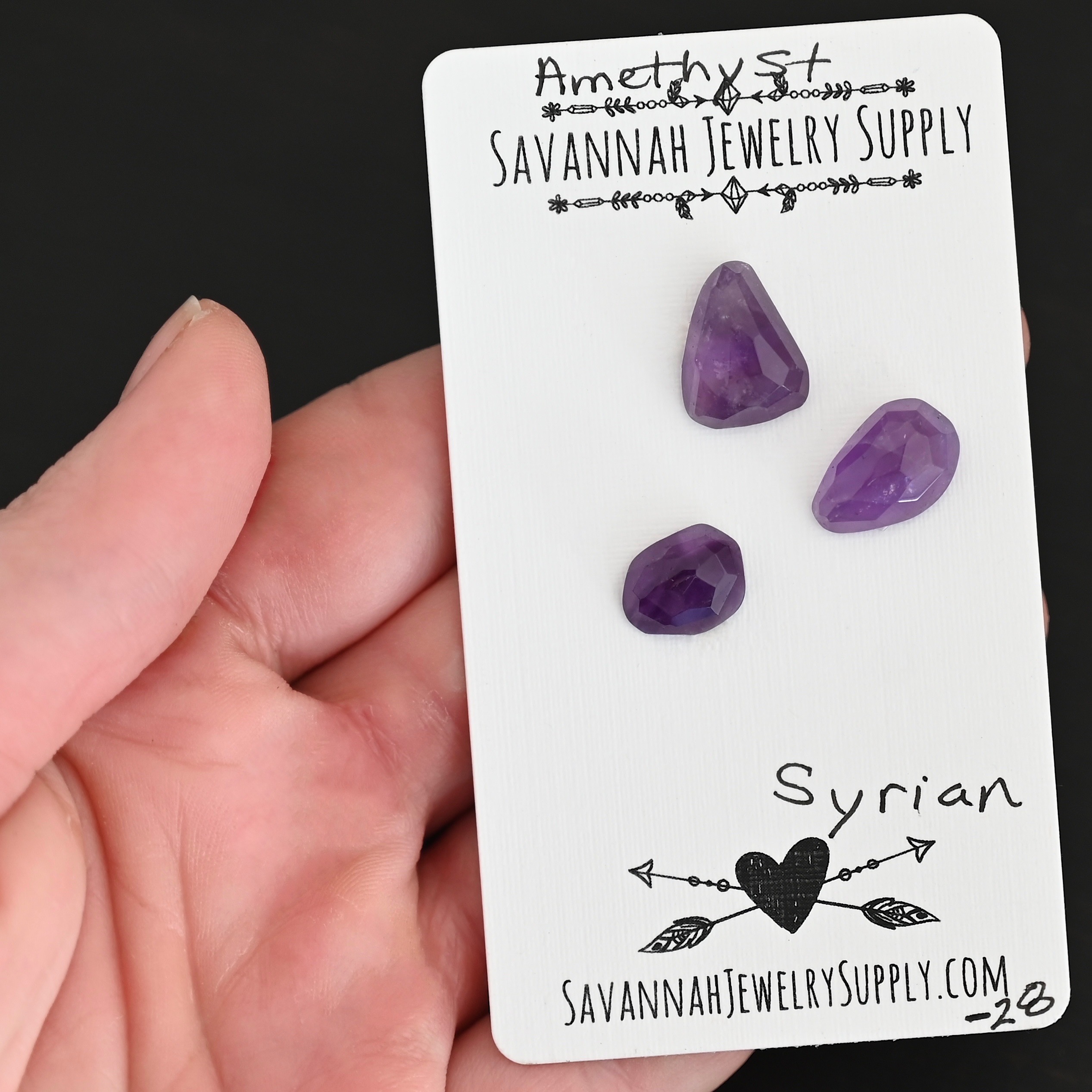 Syrian Rose Cut Amethyst Cabochon Parcel shown in hand