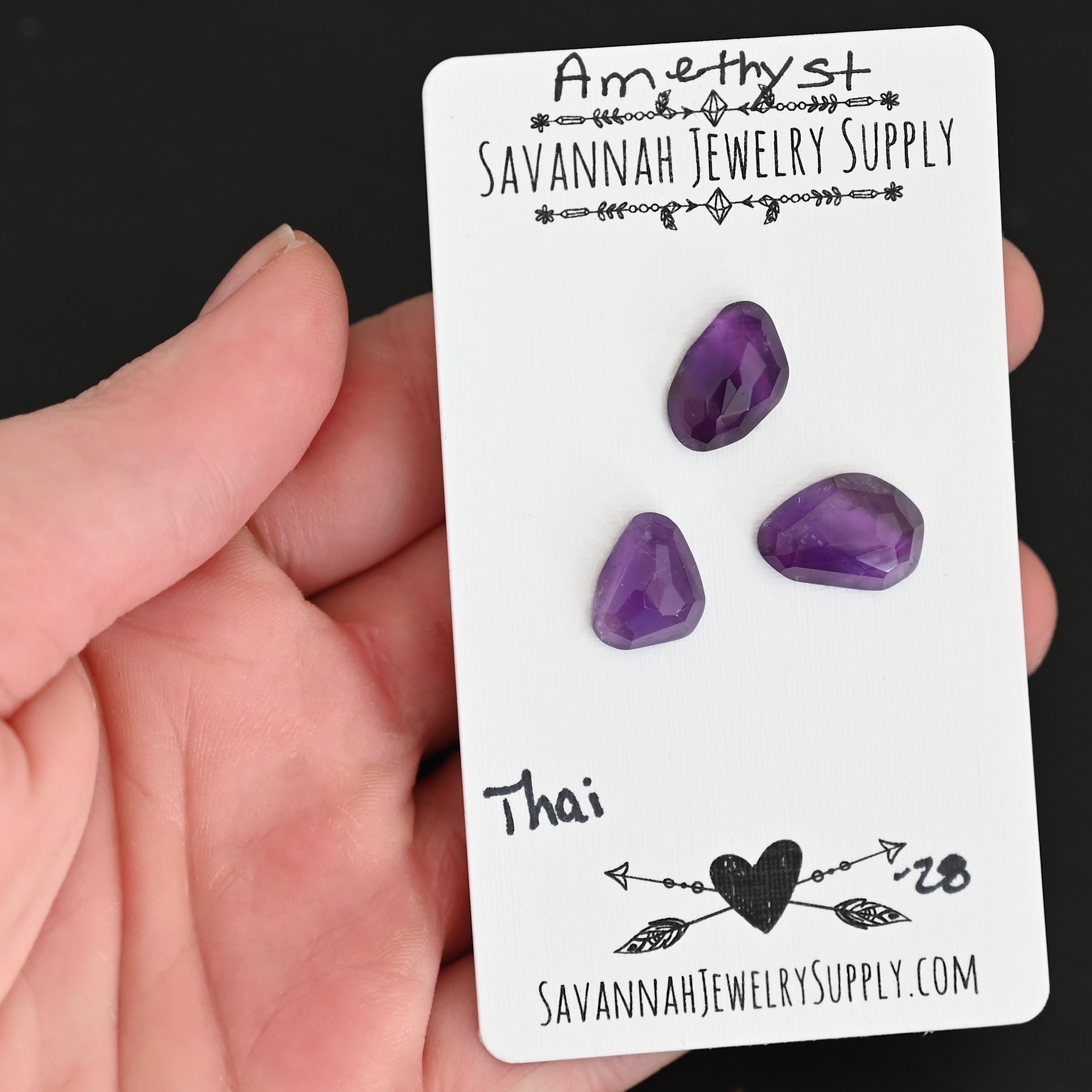 Thai Rose Cut Amethyst Cabochon Parcel shown in hand