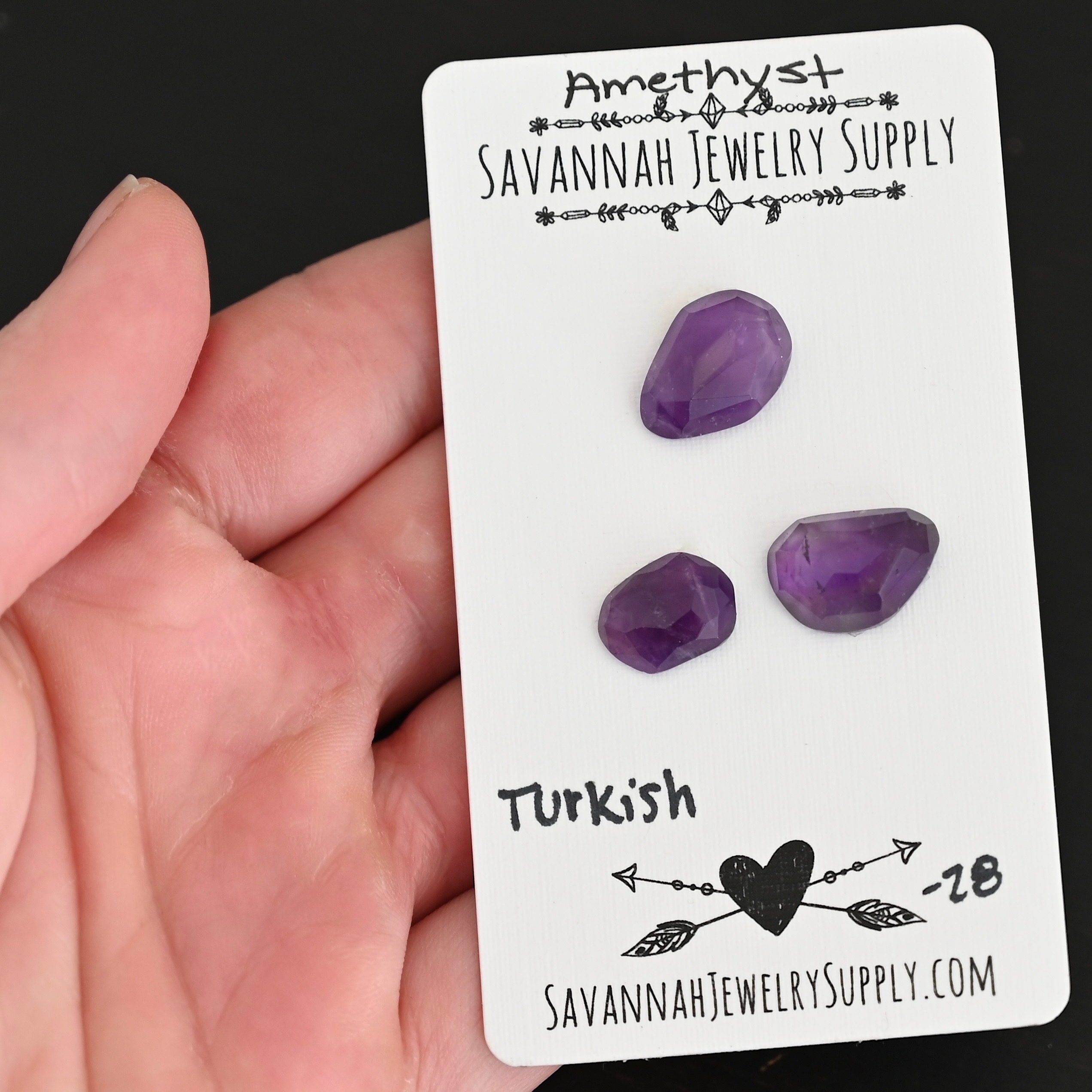 Turkish Rose Cut Amethyst Cabochon Parcel shown in hand