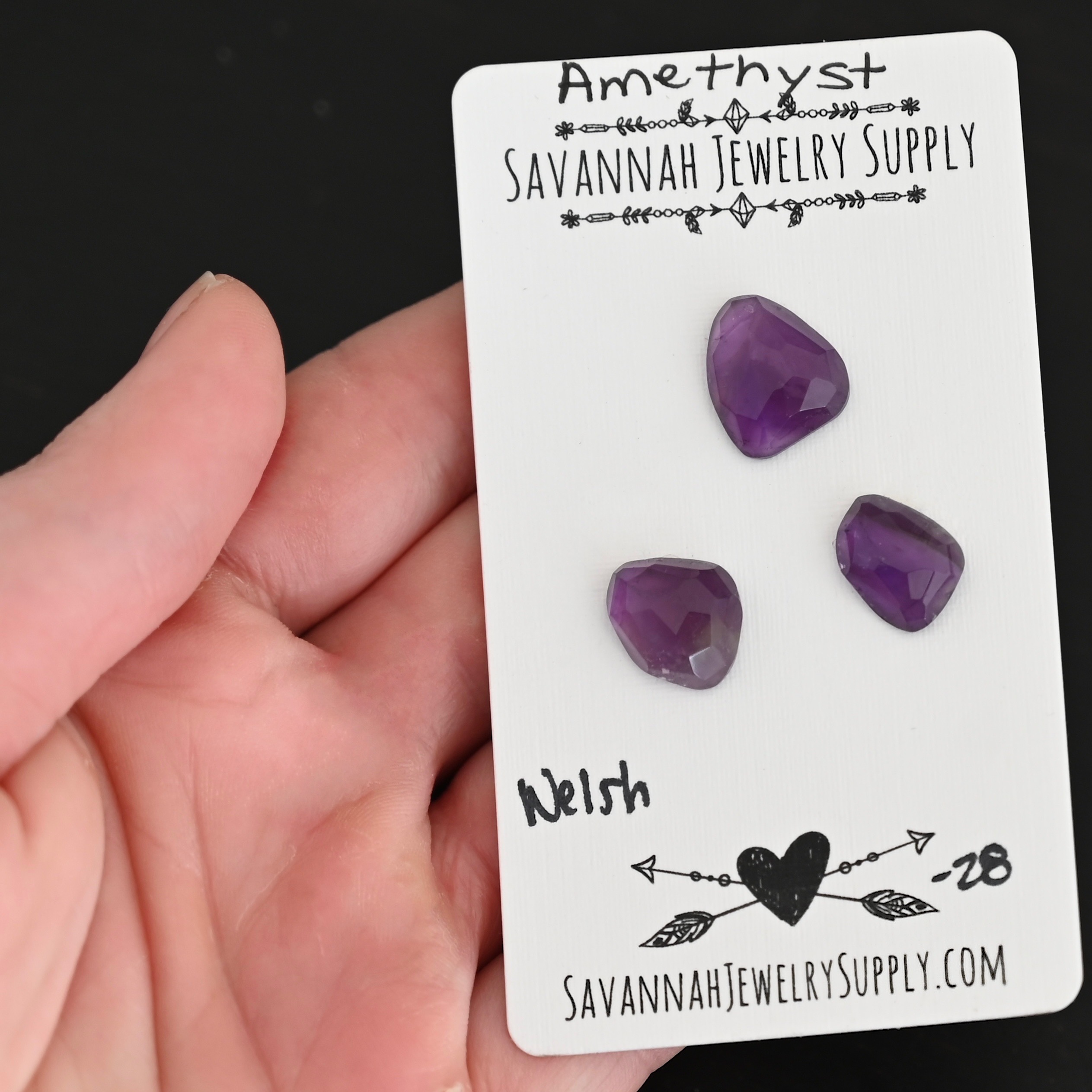 Welsh Rose Cut Amethyst Cabochon Parcel shown in hand