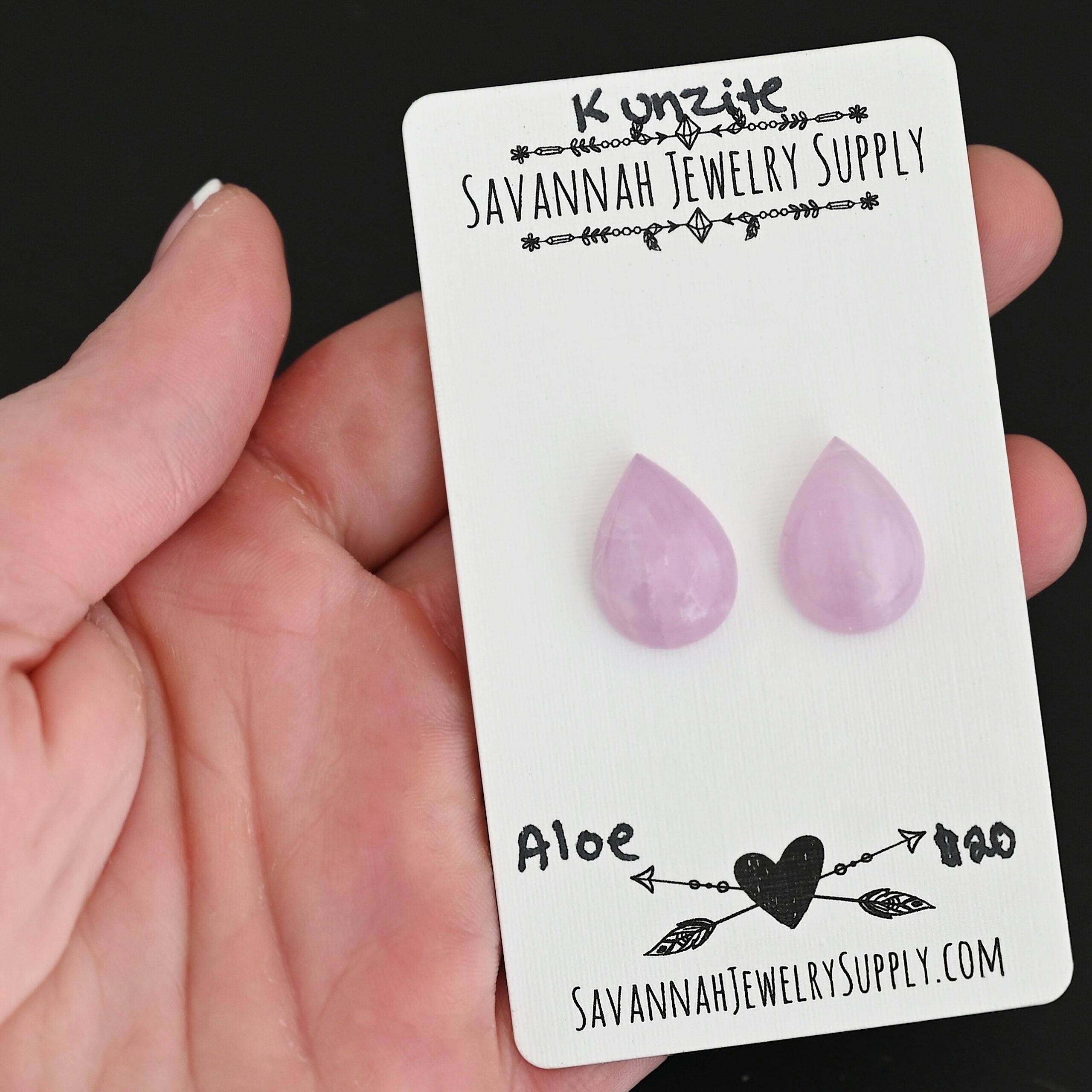 Aloe Kunzite Cabochon Parcel shown in hand