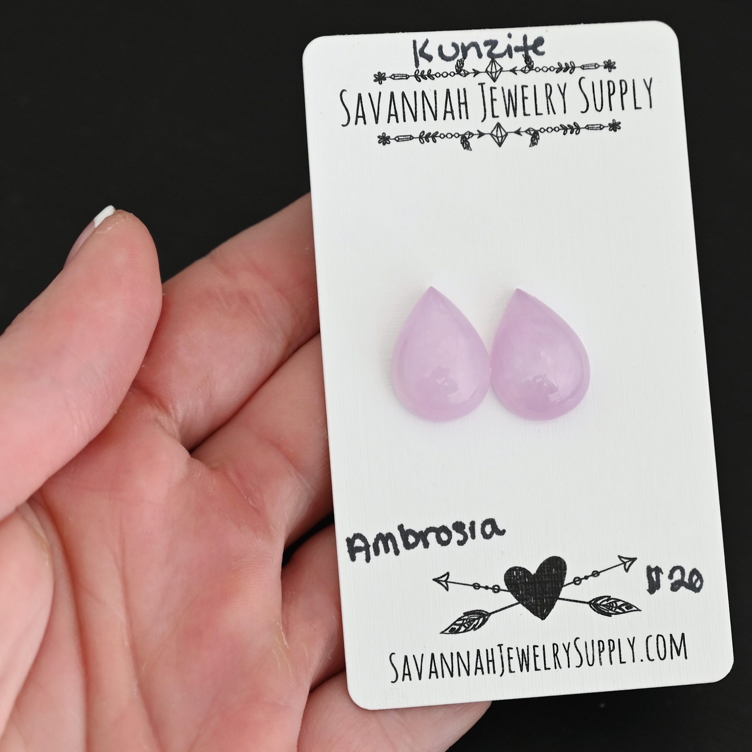 Ambrosia Kunzite Cabochon Parcel shown in hand