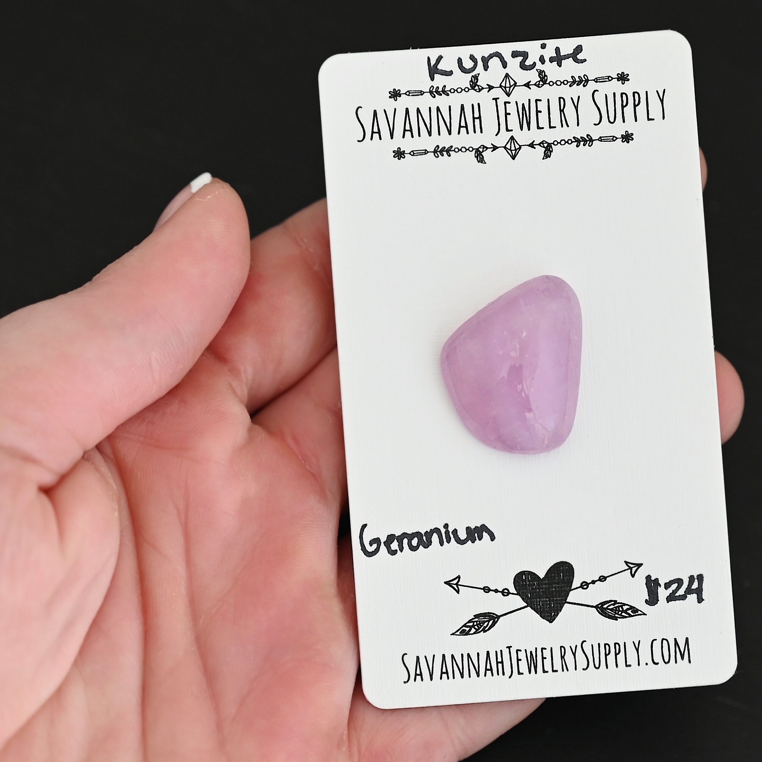 Geranium Kunzite Cabochon Parcel shown in hand