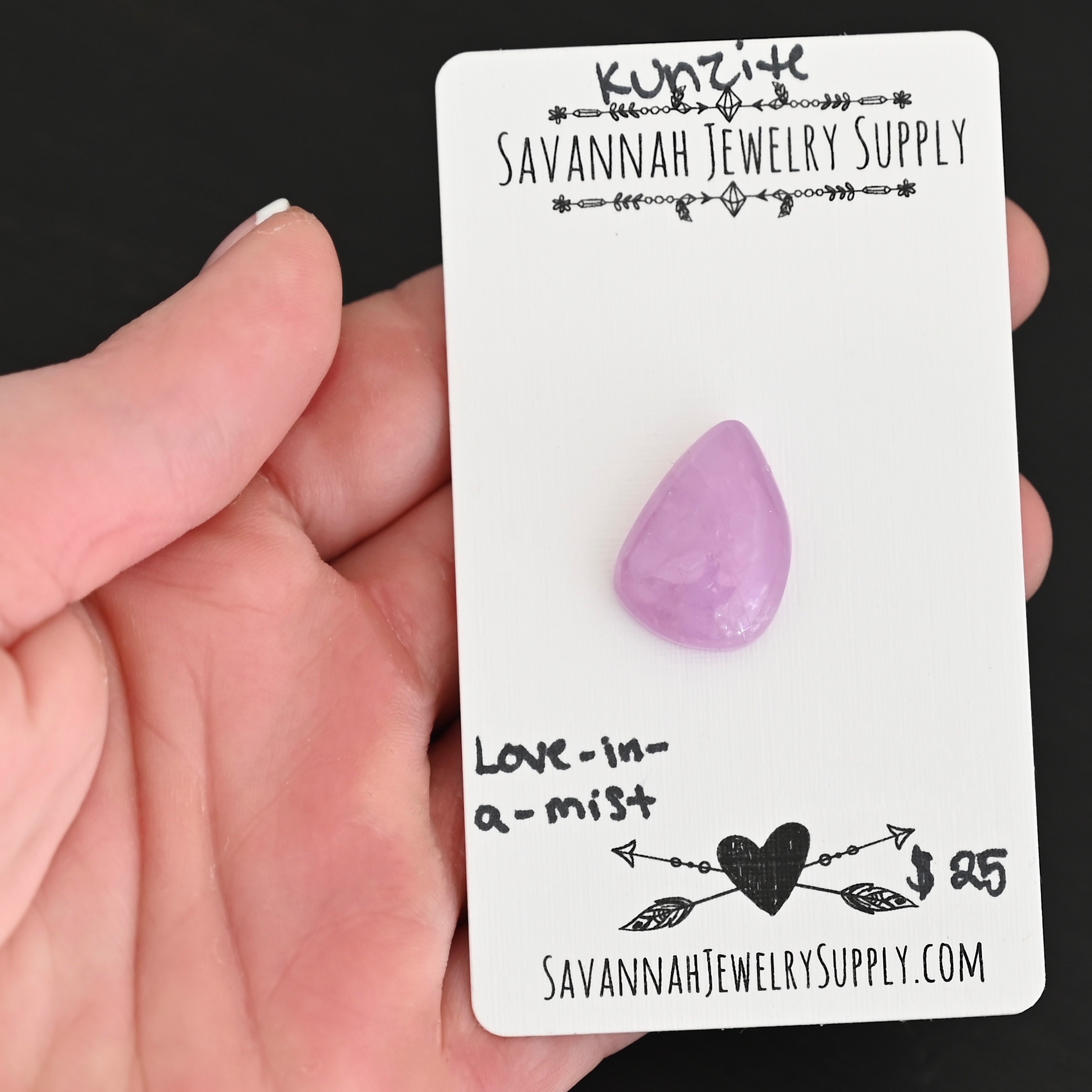 Love-In-A-Mist Kunzite Cabochon Parcel shown in hand