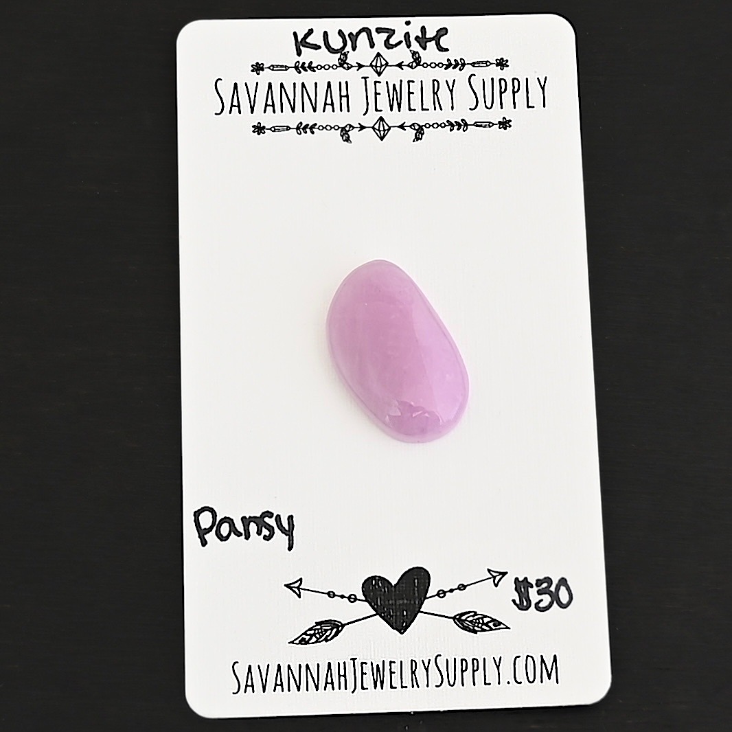 Pansy Kunzite Cabochon Parcel shown on business card