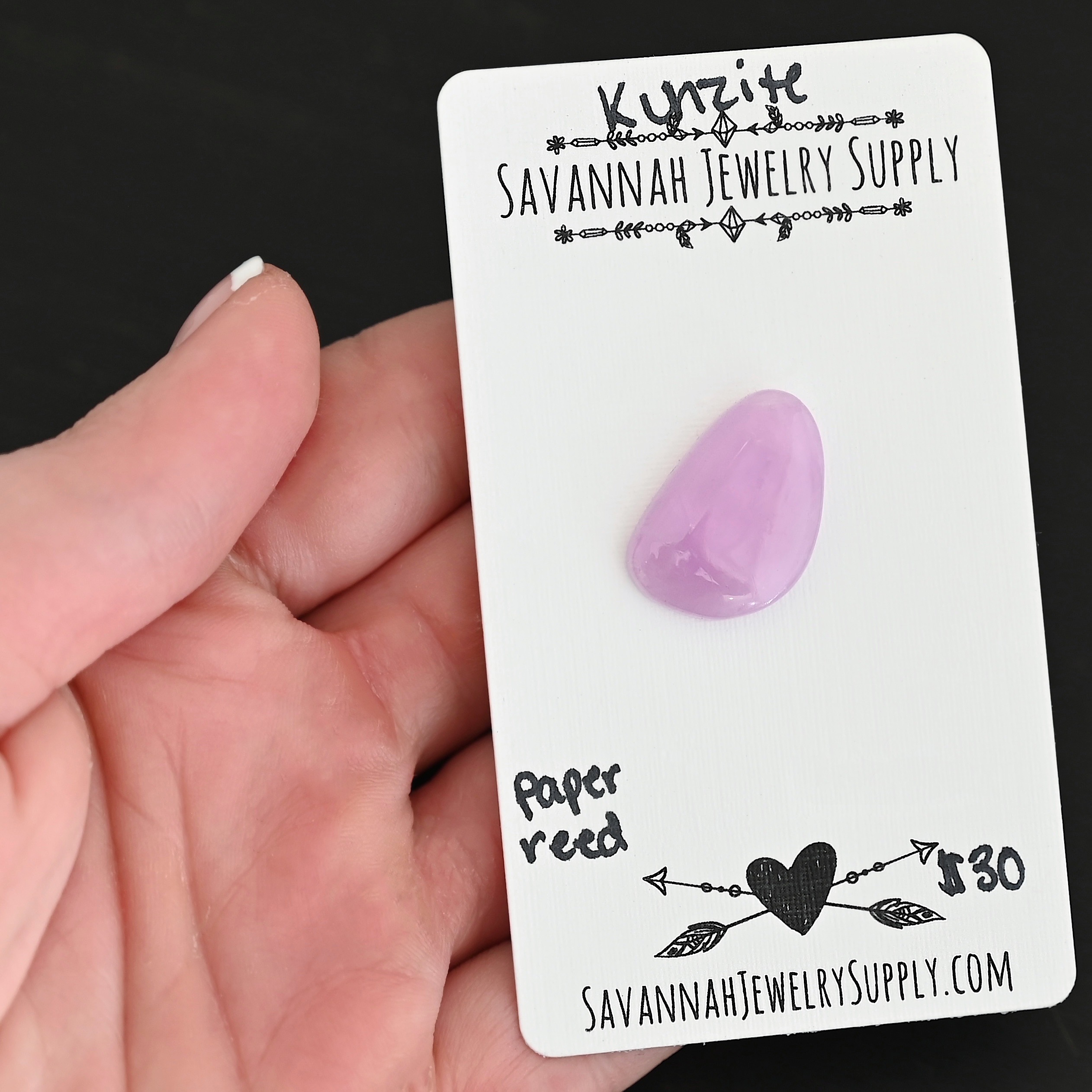 Paper Reed Kunzite Cabochon Parcel shown in hand