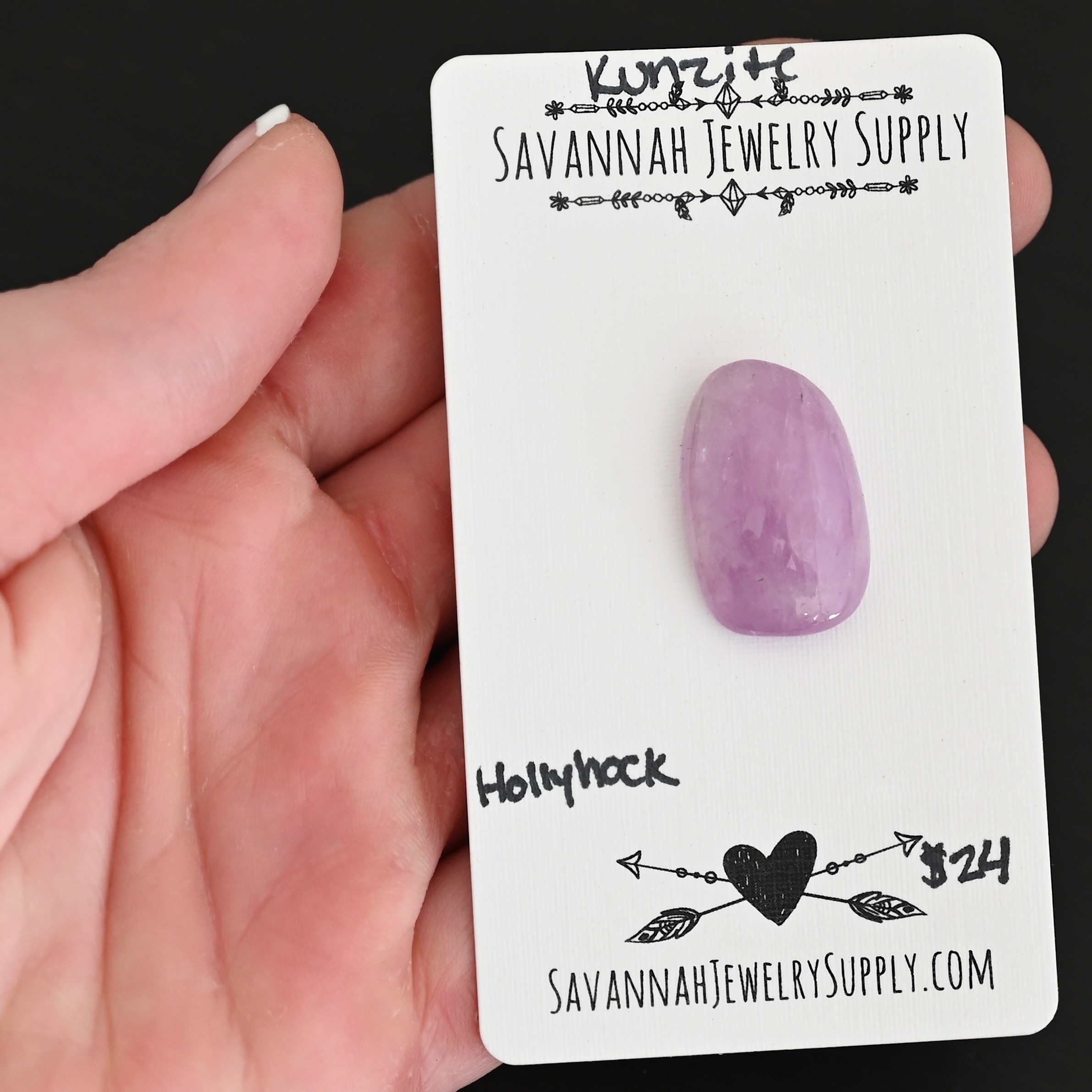 Hollyhock Kunzite Cabochon Parcel shown in hand