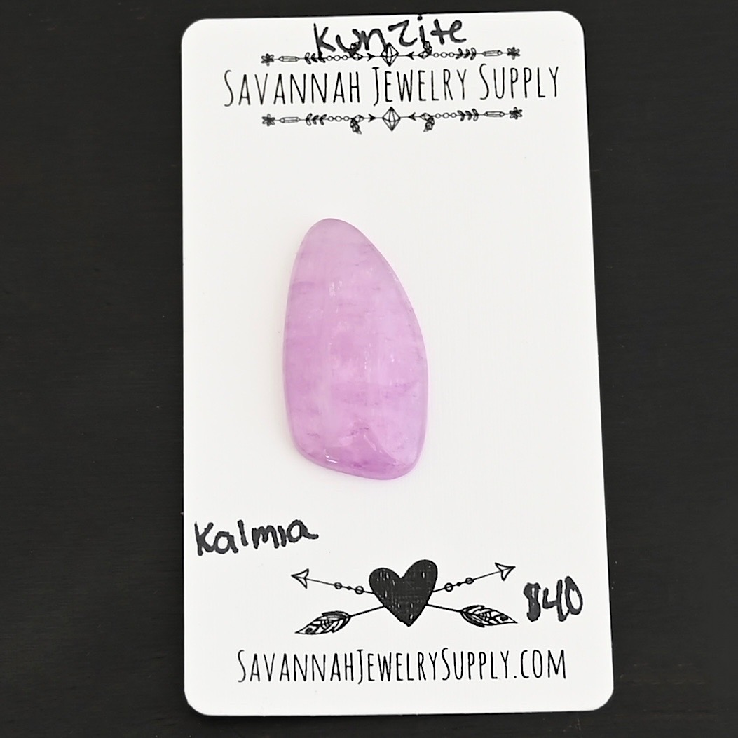 Kalmia Kunzite Cabochon Parcel shown on business card