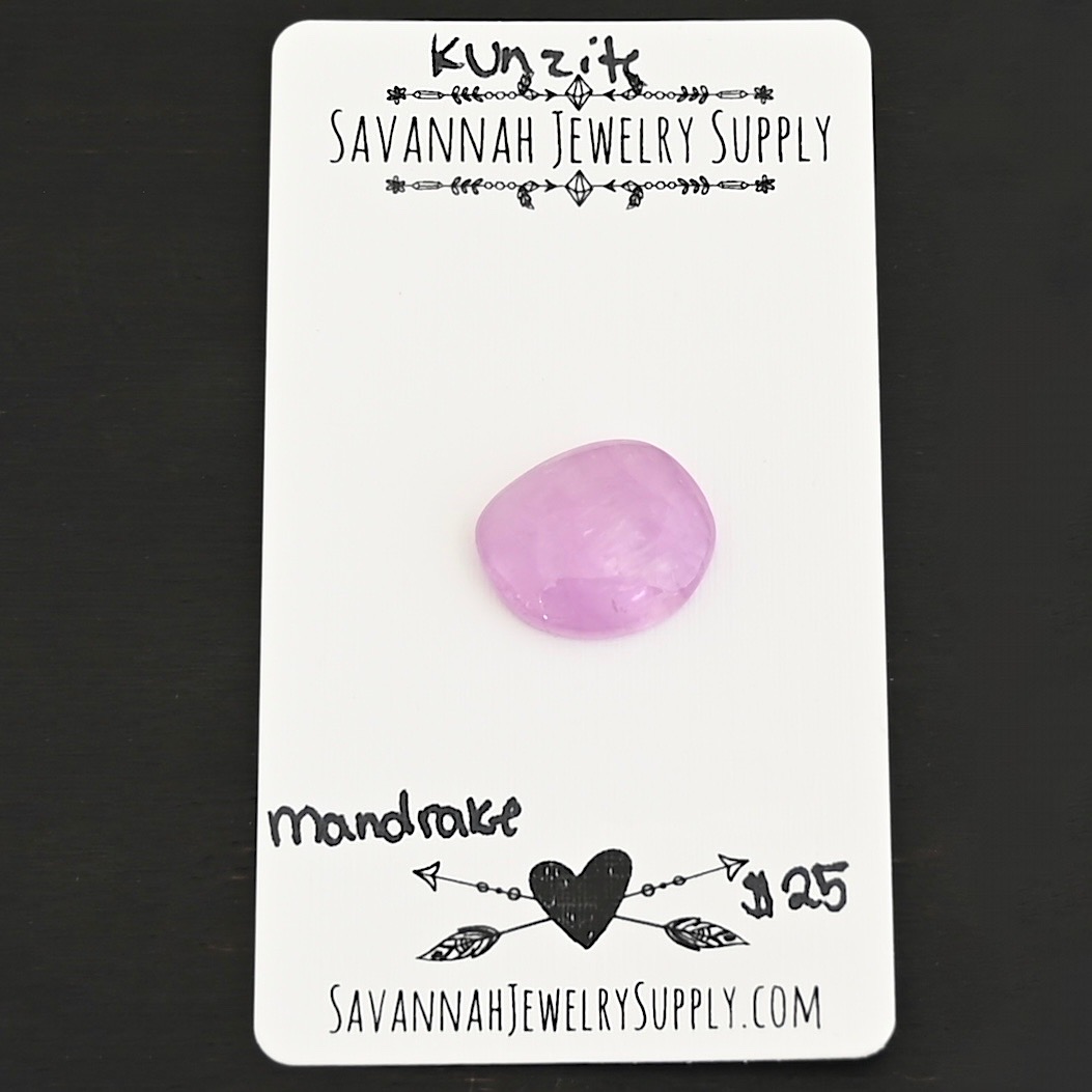 Mandrake Kunzite Cabochon Parcel shown on business card