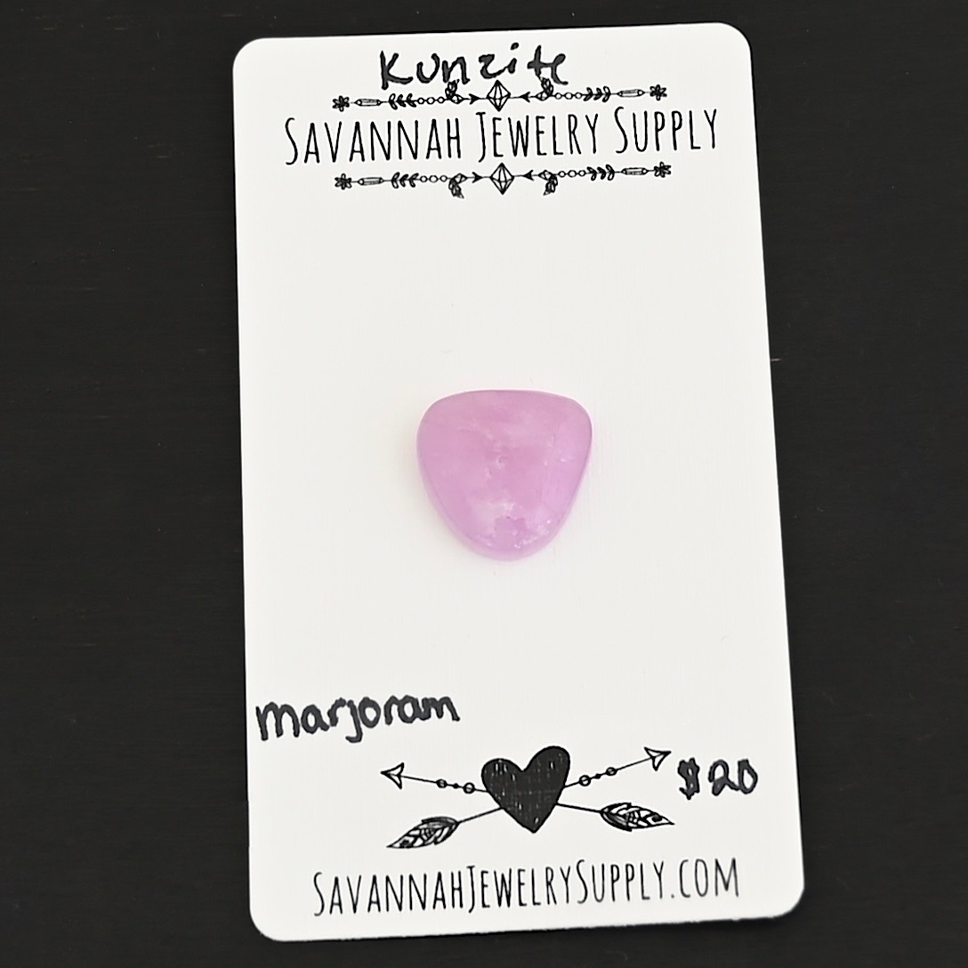 Marjoram Kunzite Cabochon Parcel shown on business card