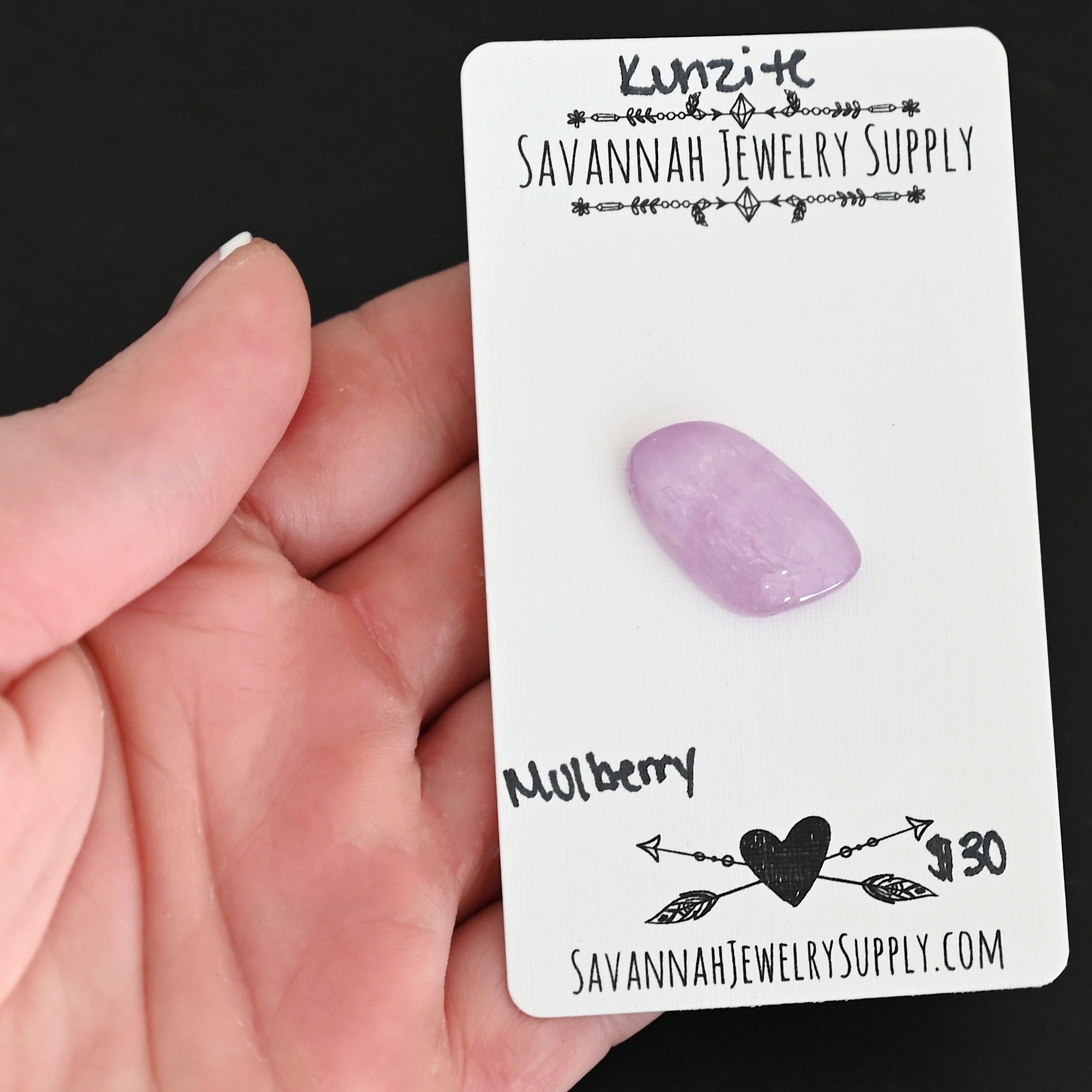 Mulberry Kunzite Cabochon Parcel shown in hand