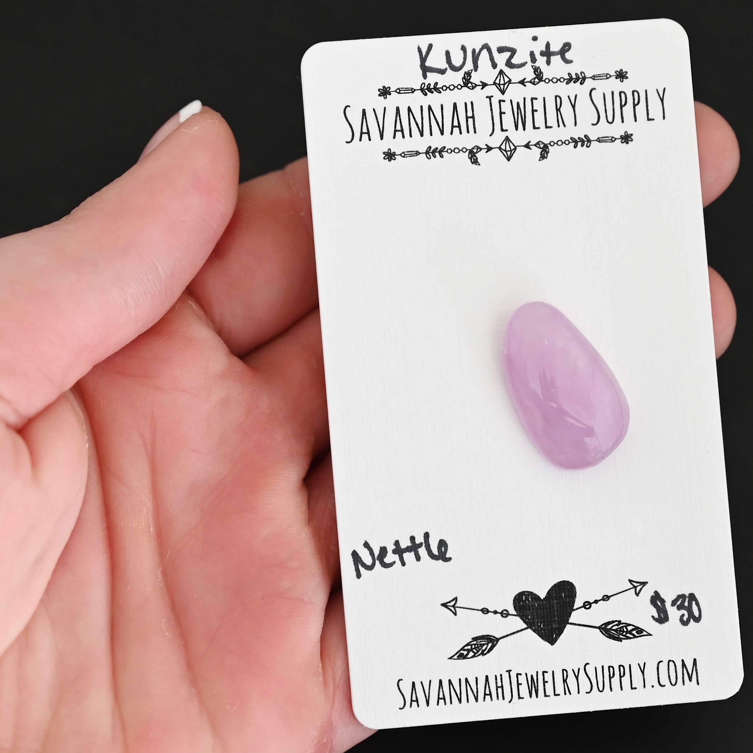 Nettle Kunzite Cabochon Parcel shown in hand