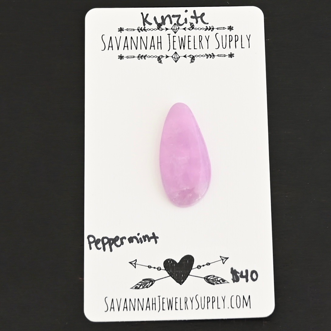 Peppermint Kunzite Cabochon Parcel shown on business card