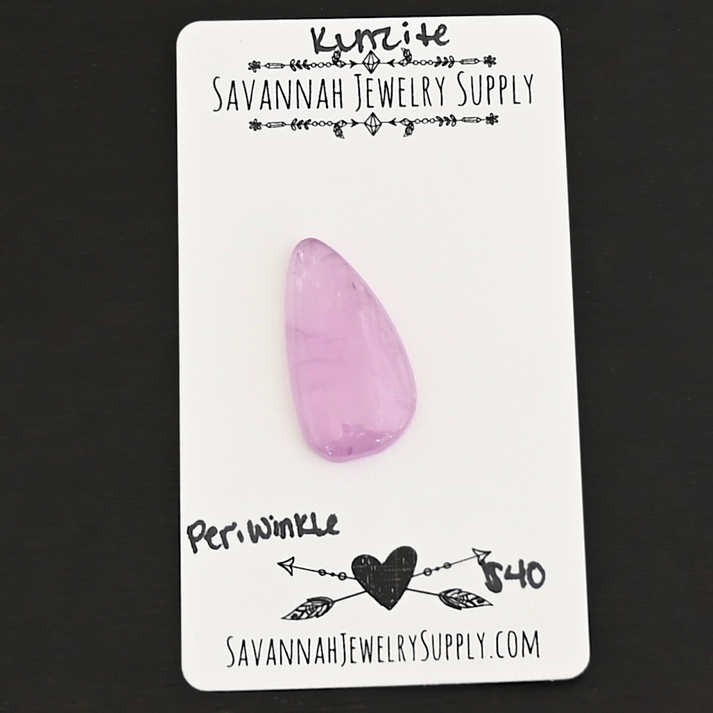 Periwinkle Kunzite Cabochon Parcel shown on business card