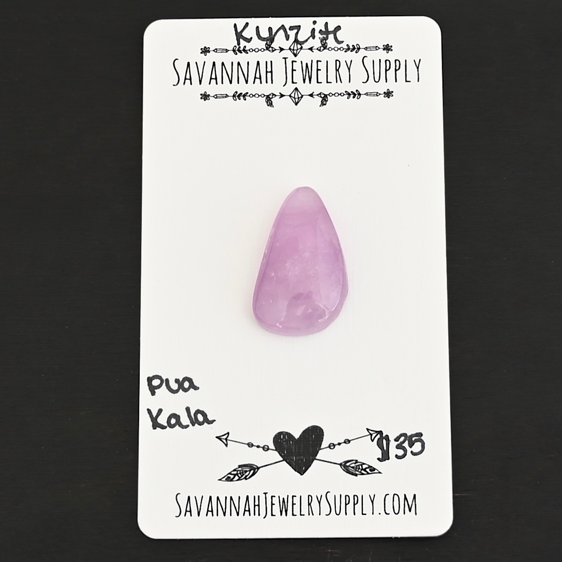 Pua Kala Kunzite Cabochon Parcel shown on business card