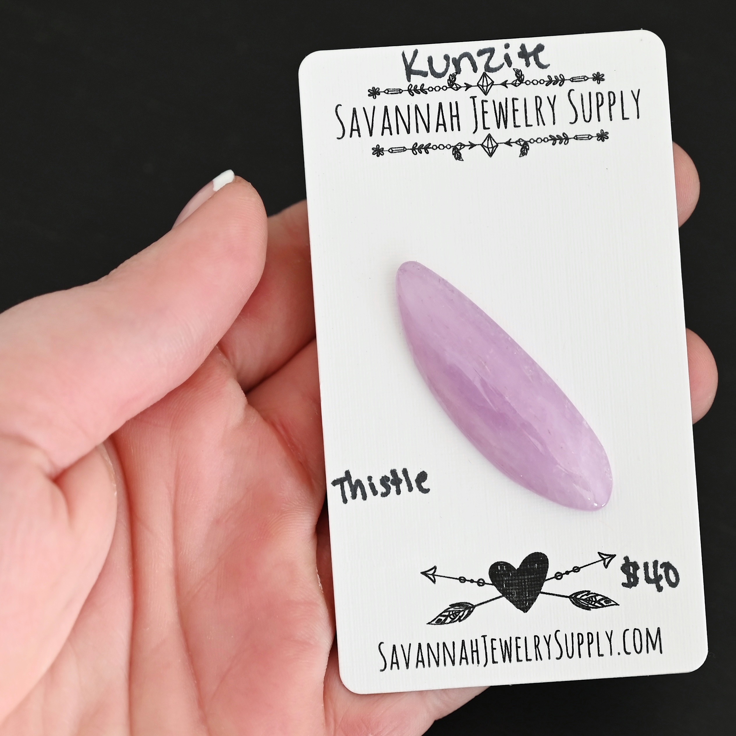 Thistle Flower Kunzite Cabochon Parcel shown in hand