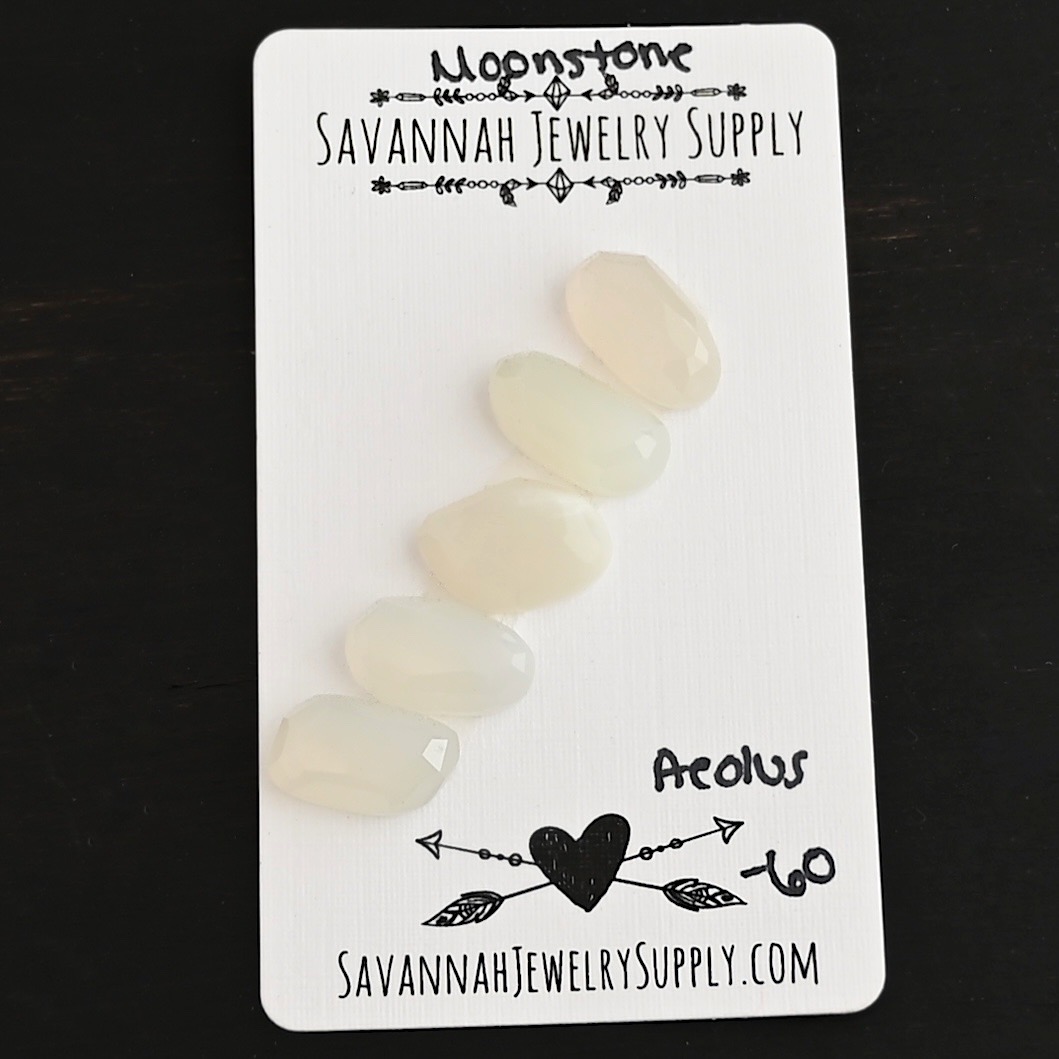 Aelous Rose Cut Moonstone Cabochon Parcel shown on business card