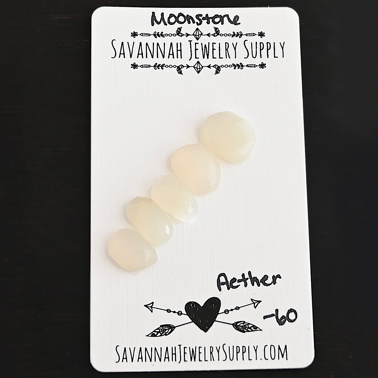 Aether Rose Cut Moonstone Cabochon Parcel shown on business card