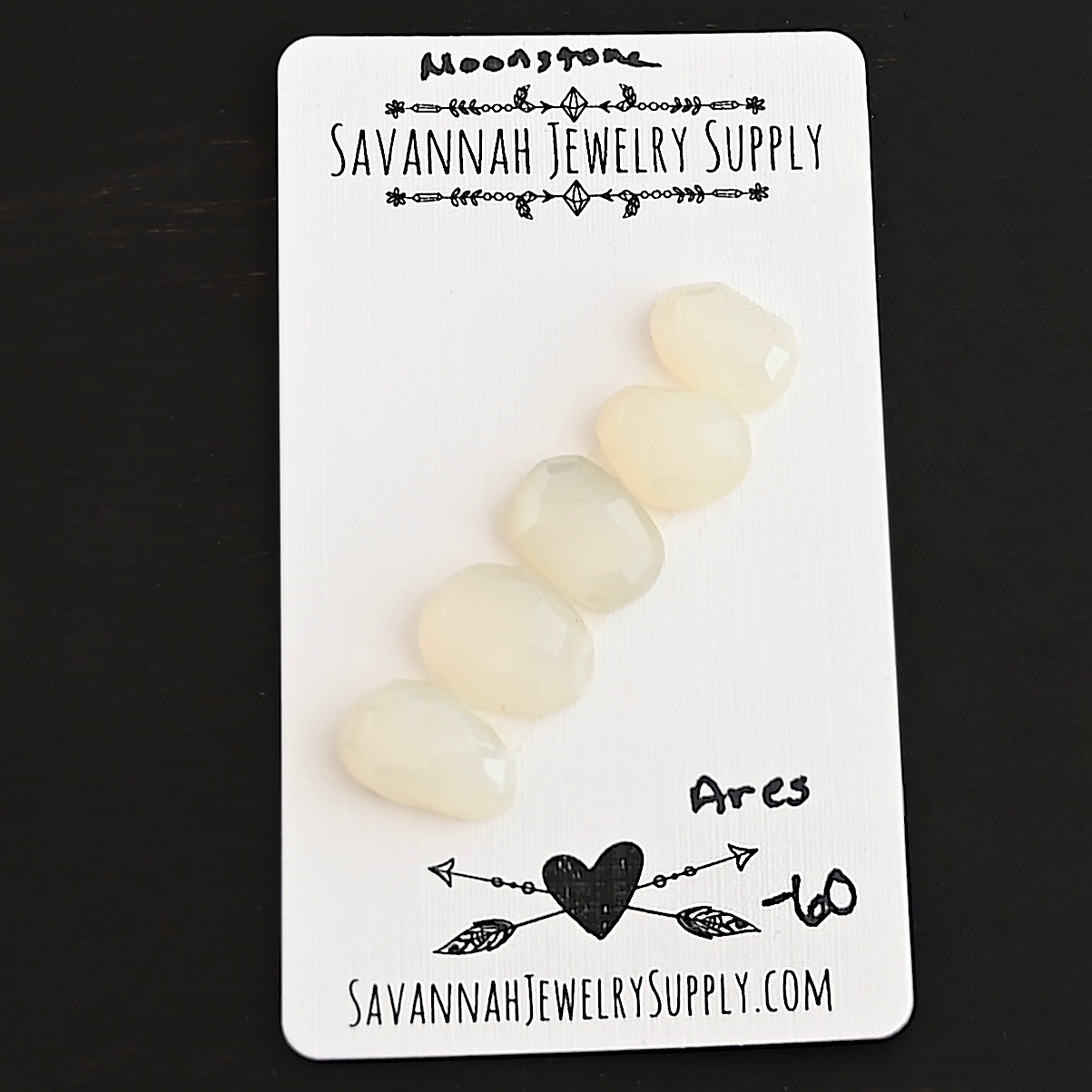 Ares Rose Cut Moonstone Cabochon Parcel shown on business card