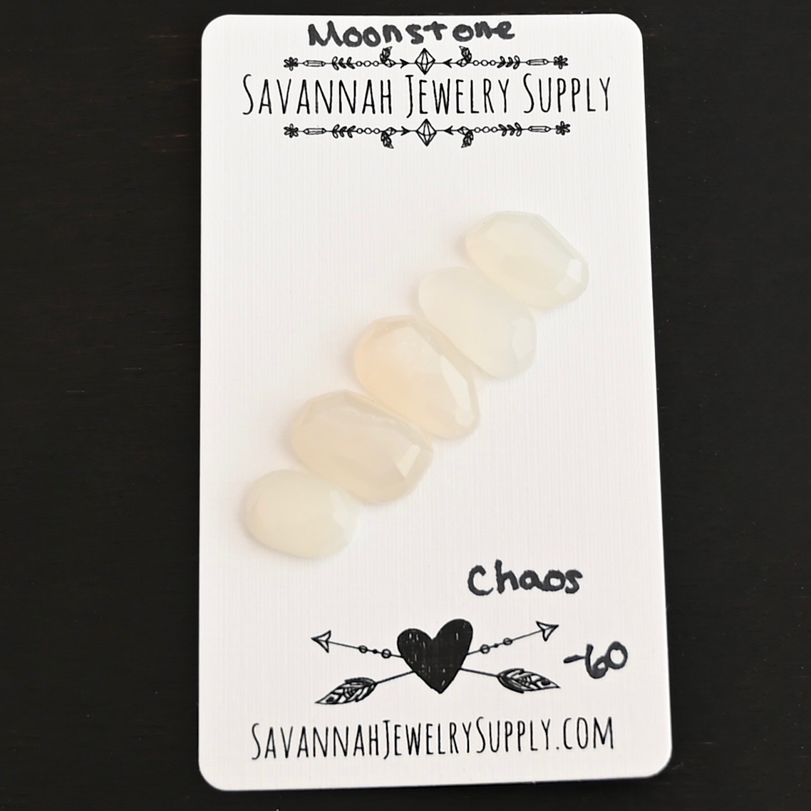 Chaos Rose Cut Moonstone Cabochon Parcel shown on business card