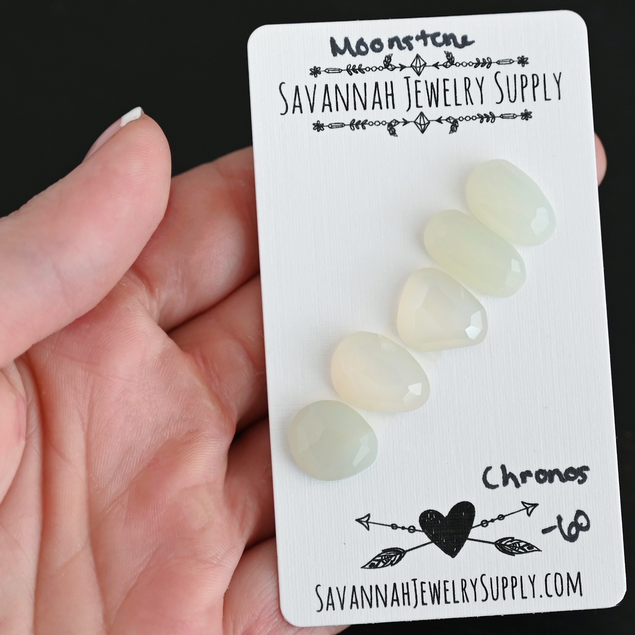 Chronos Rose Cut Moonstone Cabochon Parcel shown in hand