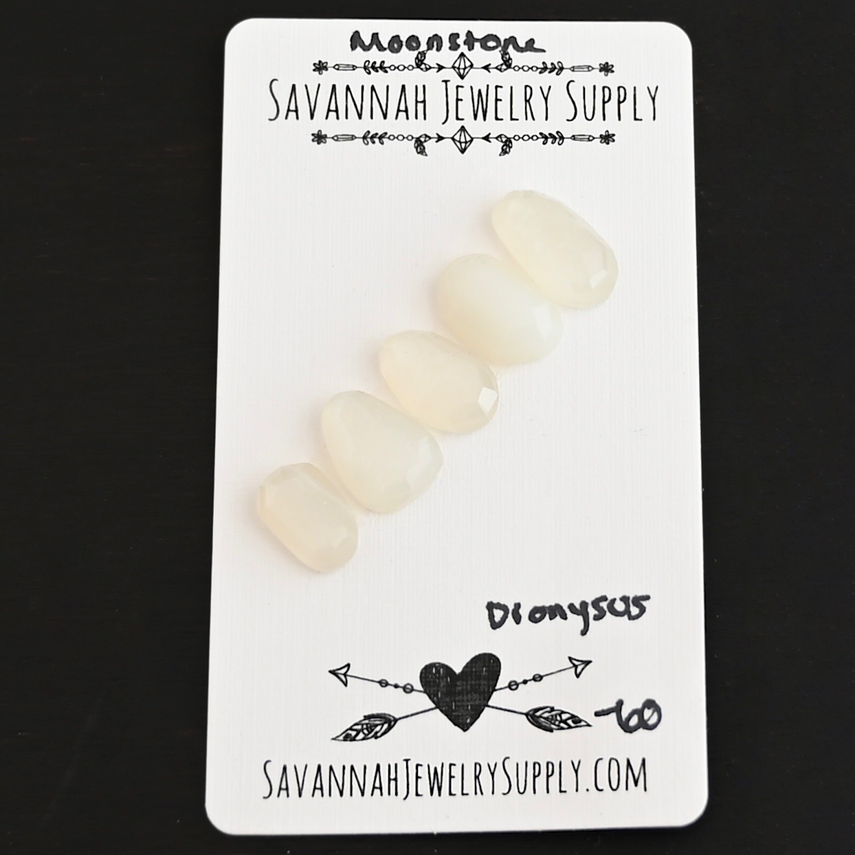 Dionysus Rose Cut Moonstone Cabochon Parcel shown on business card