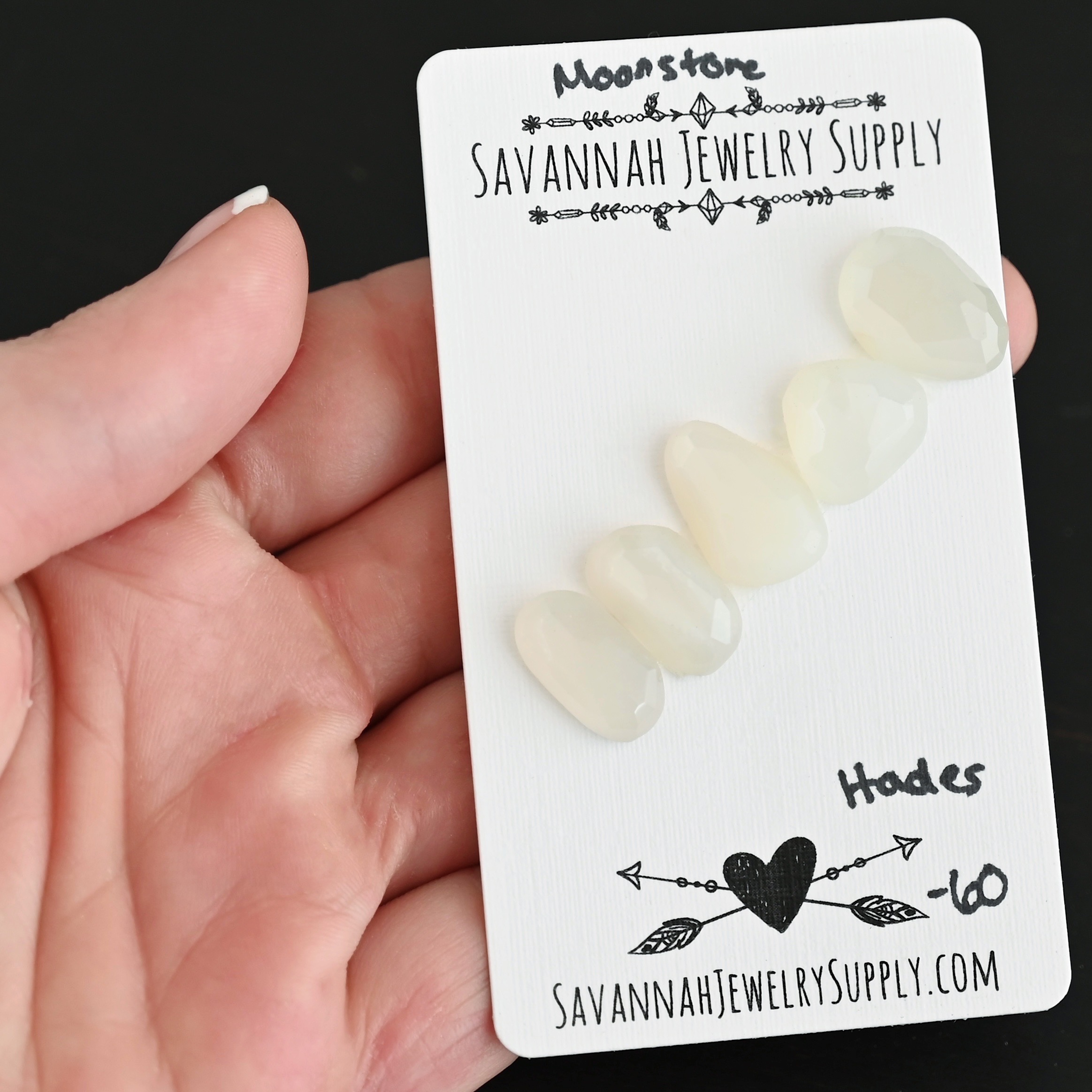 Hades Rose Cut Moonstone Cabochon Parcel shown in hand