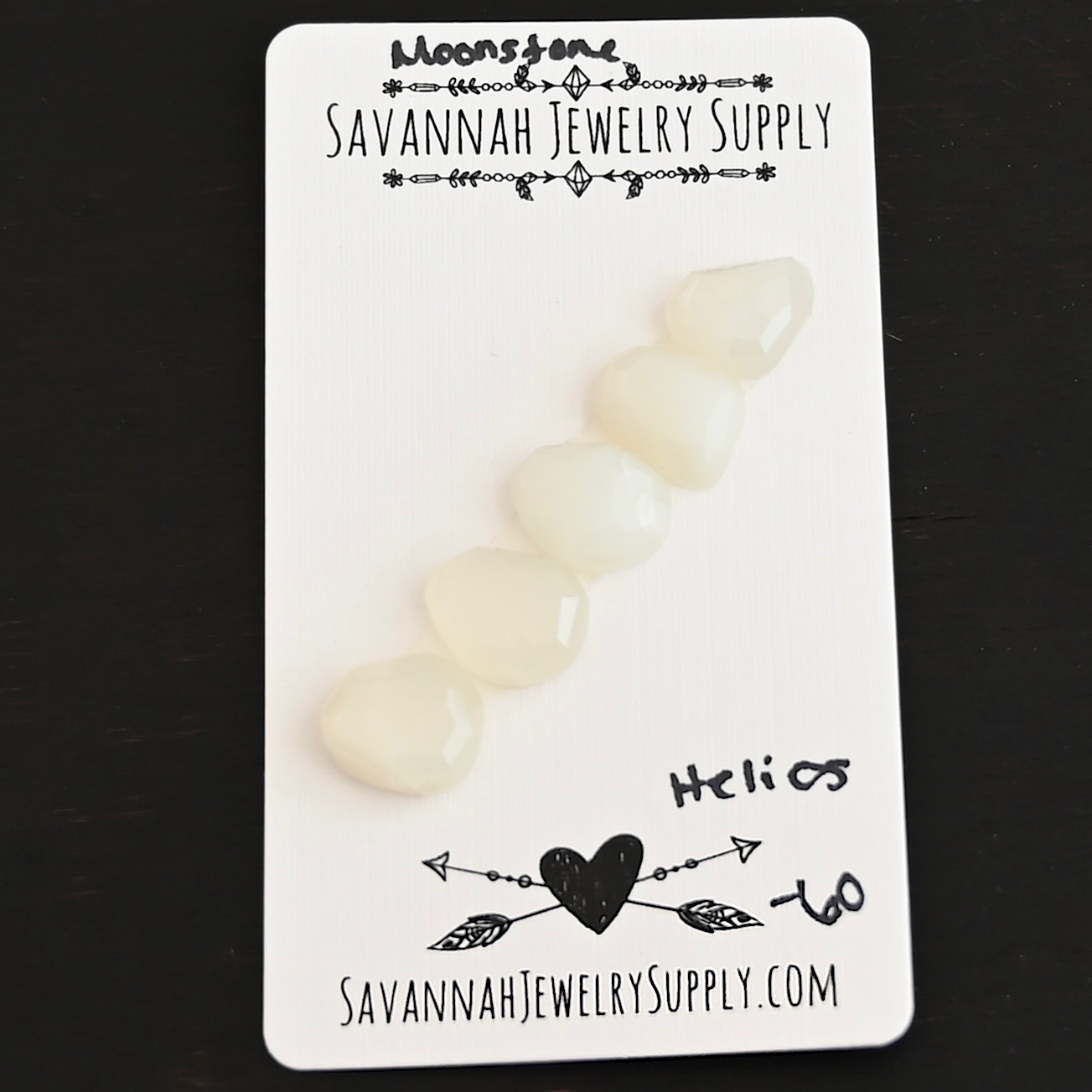 Helios Rose Cut Moonstone Cabochon Parcel shown on business card