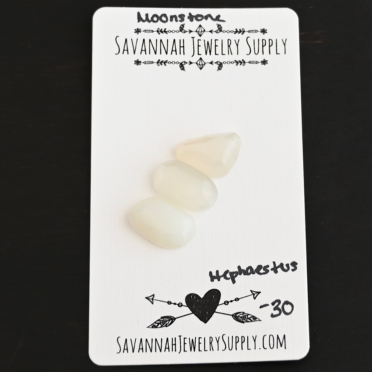 Hephaestus Rose Cut Moonstone Cabochon Parcel shown on business card