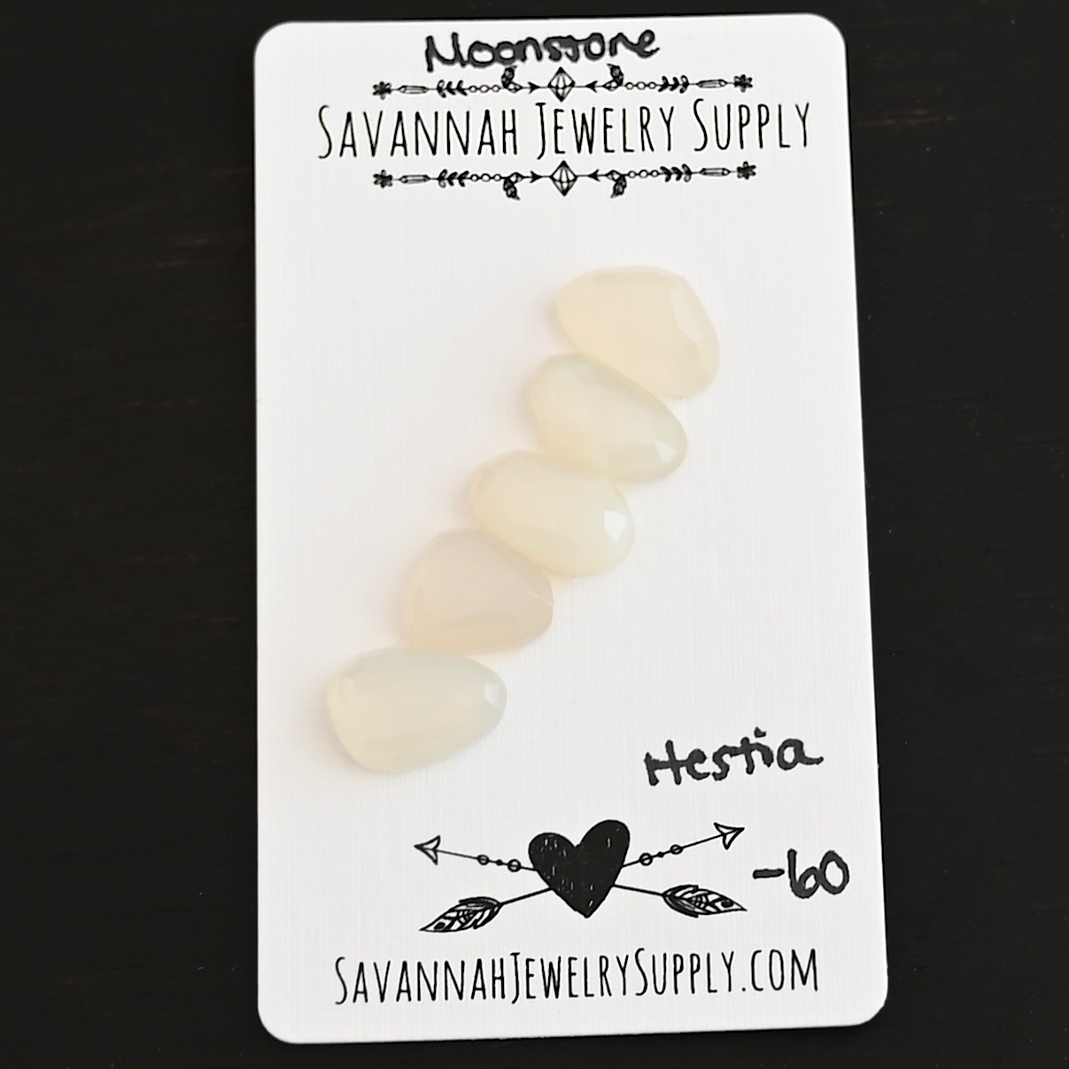 Hestia Rose Cut Moonstone Cabochon Parcel shown on business card